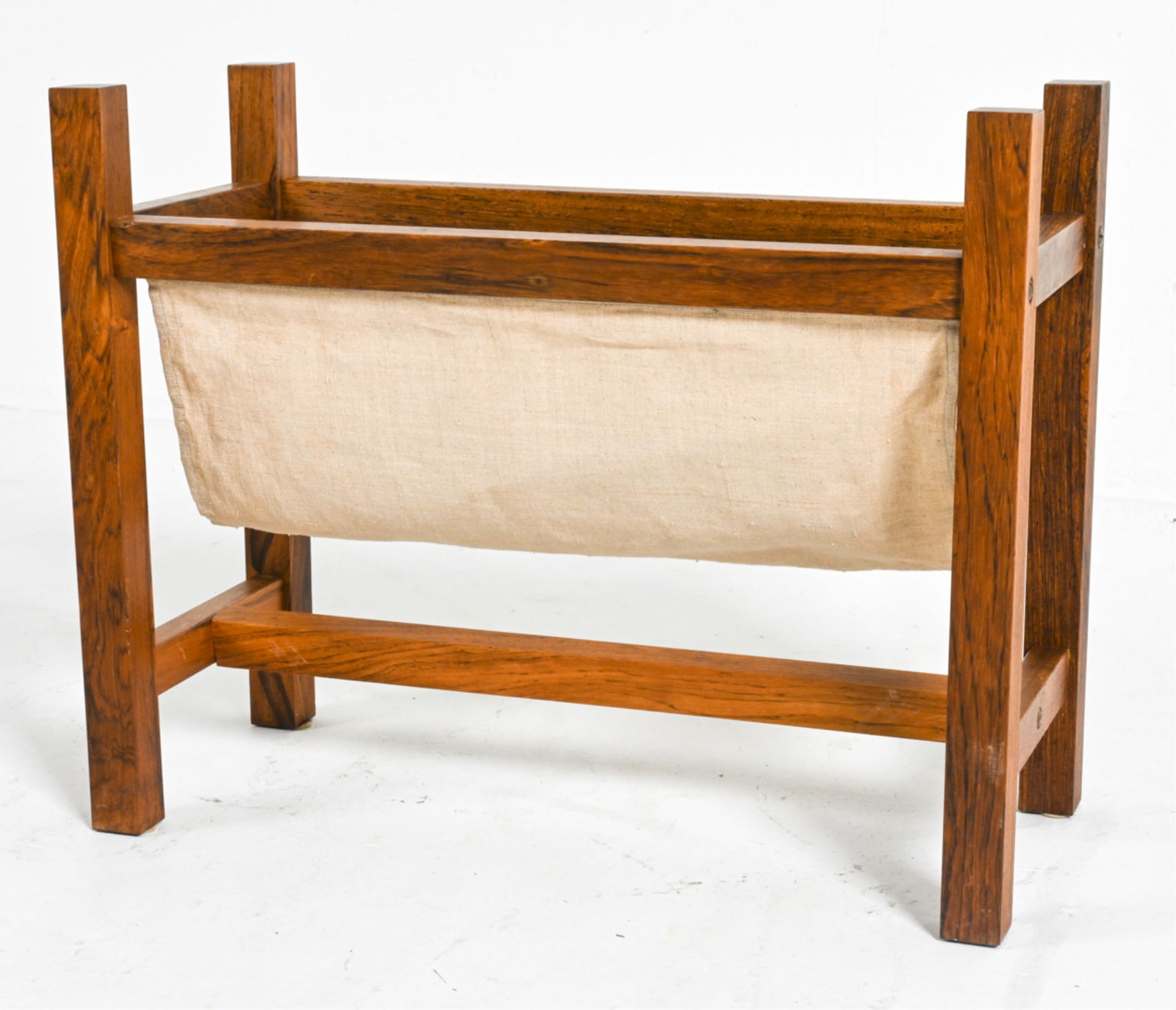DANISH ROSEWOOD & LINEN MAGAZINE RACK: c. 1970's. Dimensions: H 17" x W 21" x D 9.75". Condition: Frame with minor sun fading, a few nicks and dings. A few small pulls and marks to linen. A085
