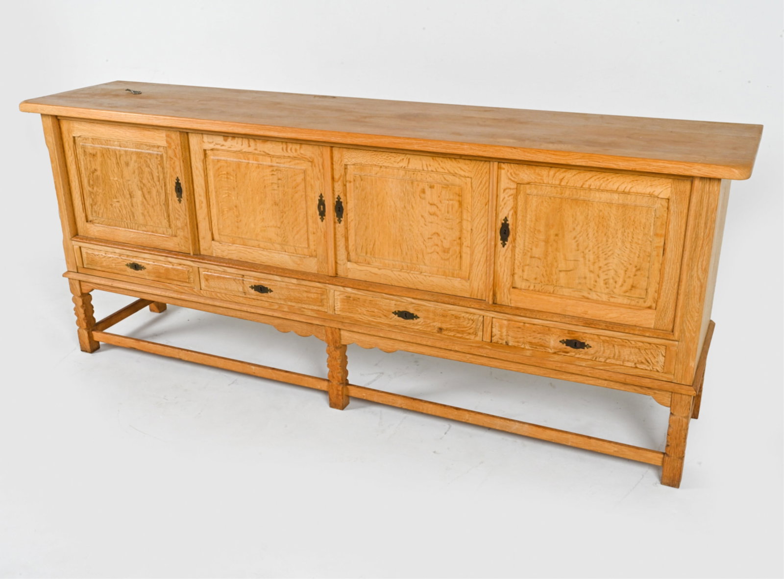 MANNER OF KJAERNULF OAK SIDEBOARD: Key included. Denmark, circa 1970's. Dimensions: H 36" x W 88" x D 19.5". Condition: Some scuffs and scrapes, minor surface soiling. Wear consistent with age and use. DMF127