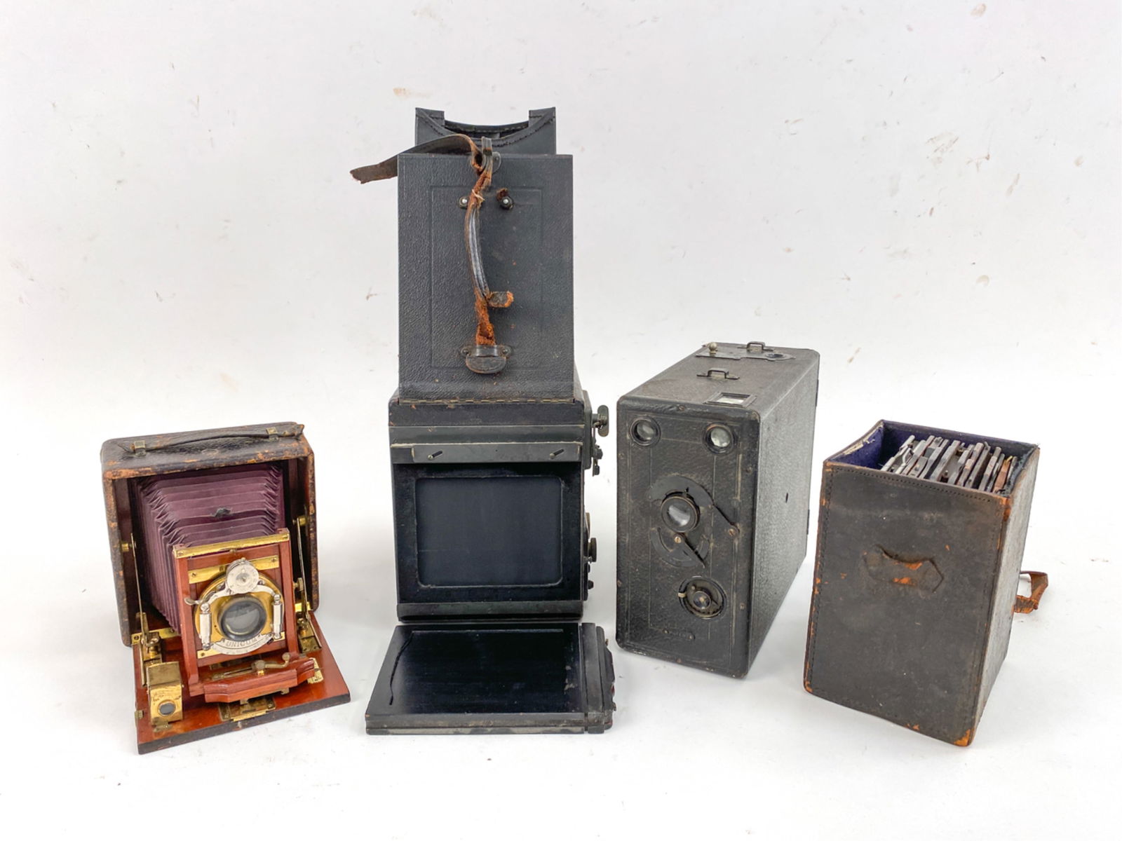 VINTAGE CAMERA GROUPING INCL GRAFLEX: Including early Graflex camera, box of film holders etc. Dimensions: (Largest) H 8.25" x W 7.5" x D 9" Condition: Surface wear, scuffs, dust and surface dirt consistent with age and use. Scattered los