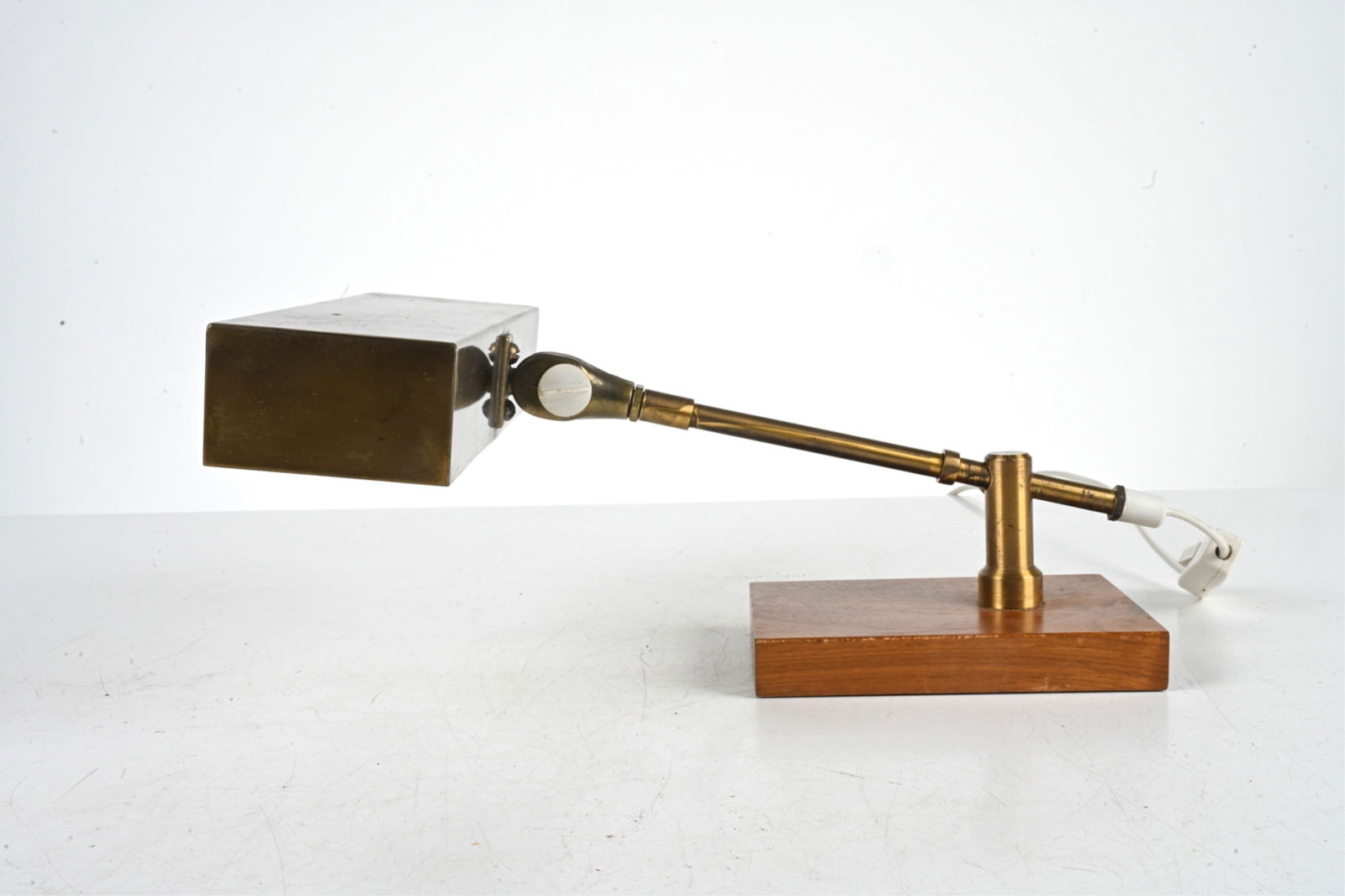 ATTR. STILO MOBLER SWEDISH BRASS & TEAK PIANO LAMP: Sweden, c. 1960's. Dimensions: H 7" x W 8.75" x D 13". Condition: Wiring untested, European plug - requires rewiring or adapter for use in the US. PF180