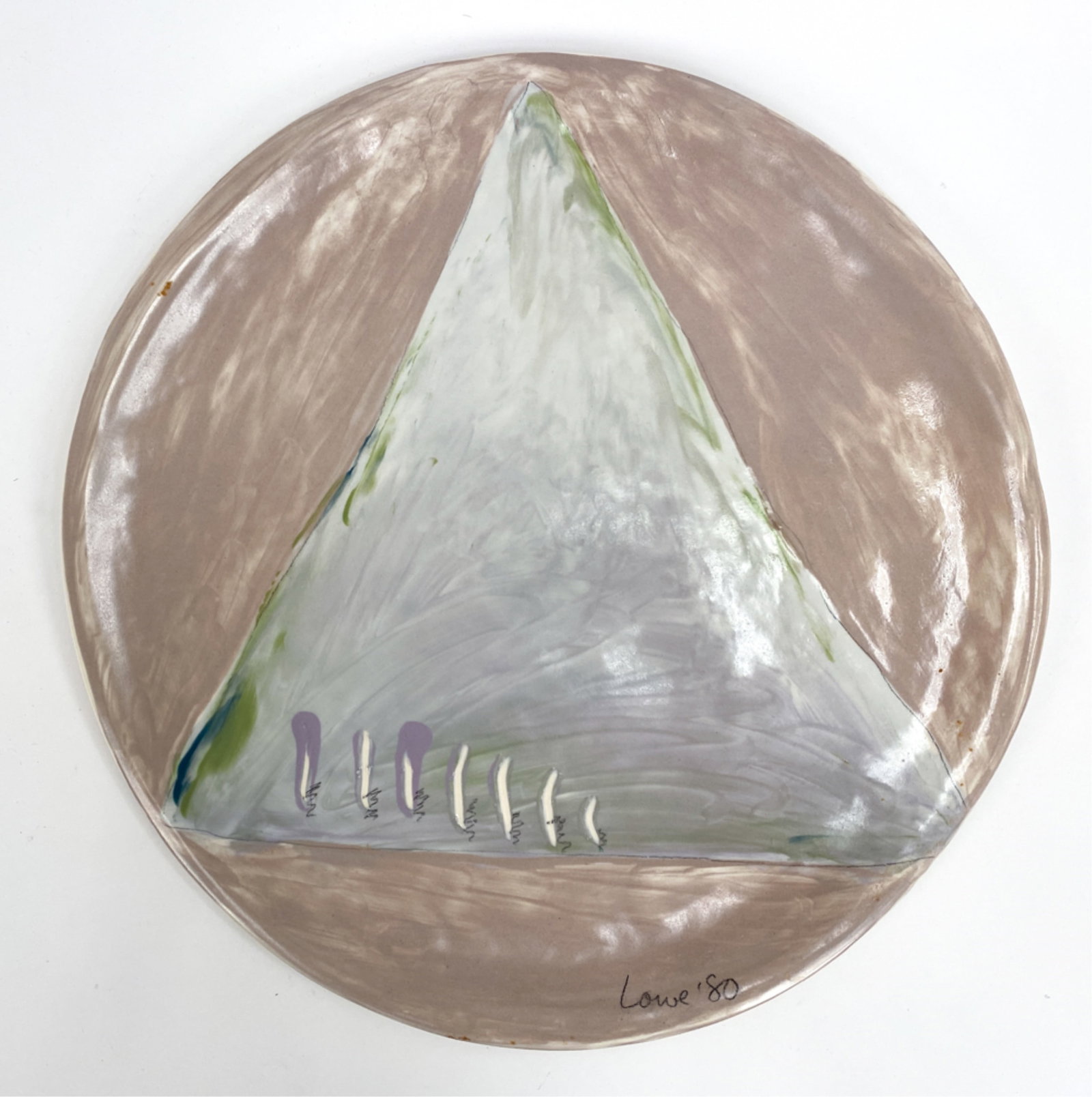 JANET LOWE HAND-FORMED HANGING PLATTER: Hand formed platter with triangular design. Meant to be hung. Signed and dated, Lowe, 80'. Dimensions: Dia 15.75" Condition: Repair to one string holder on back. Few marks.