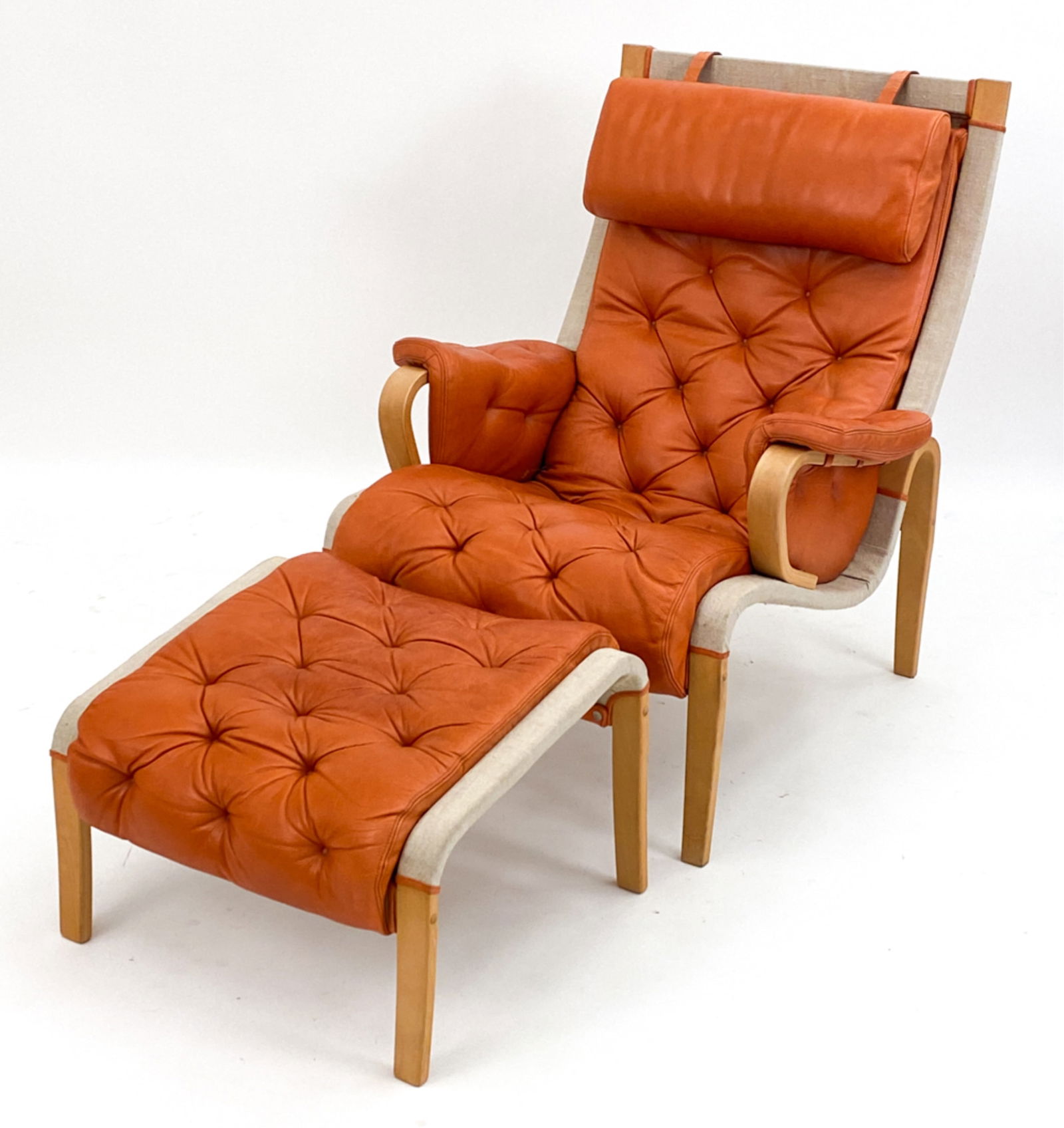 BRUNO MATHSSON STYLE BENT WOOD CHAIR & OTTOMAN: Bruno Mathsson style bentwood beech arm chair and ottoman. C.1990s. Dimensions: (Chair) H 38" x W 30.75" x D 36" x SH 17" Condition: Some wear to canvas. Light staining and distress to upholstery. D15