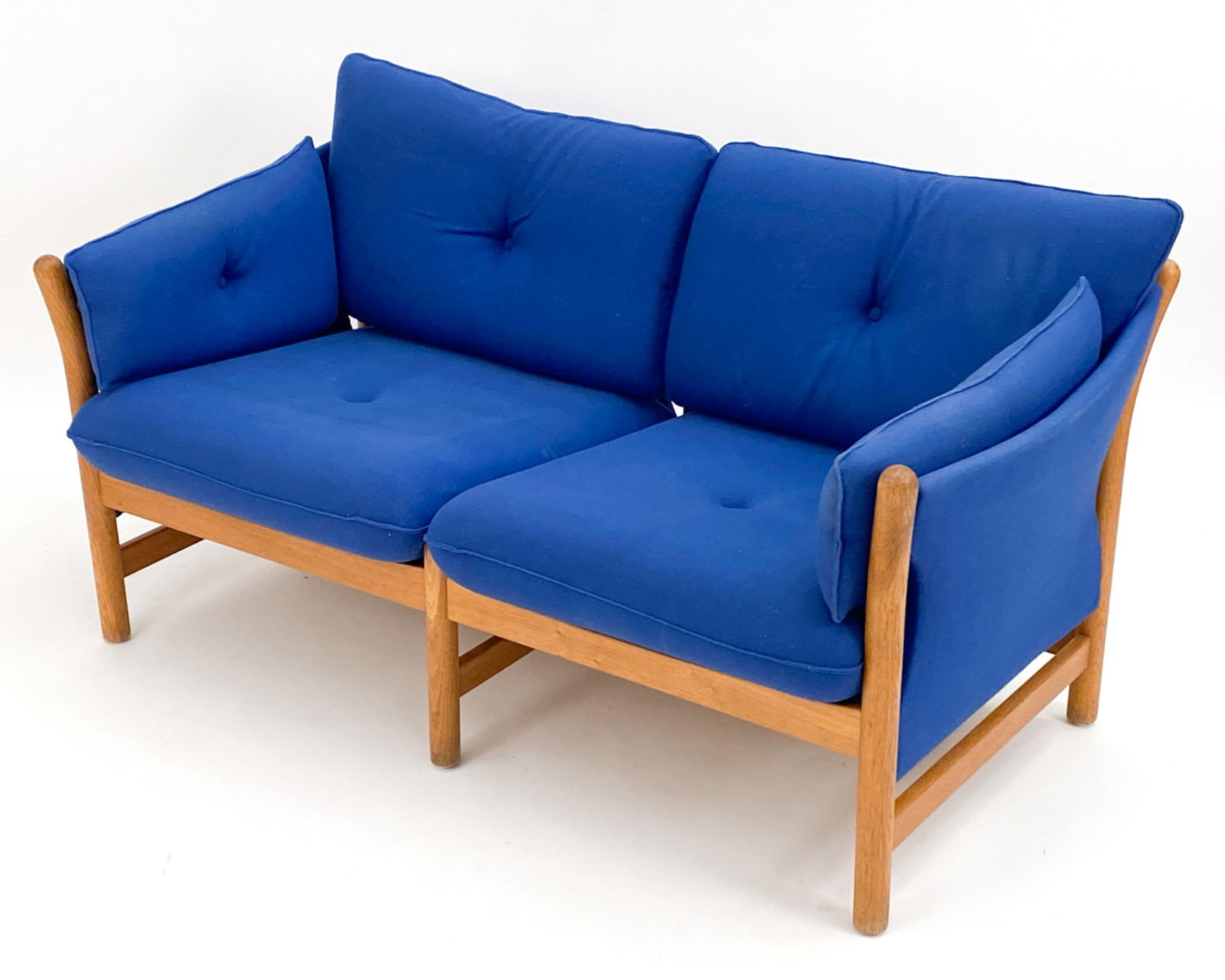 ARNE NORELL STYLE OAK SOFA C.1980: Vintage sofa in the manner of Arne Norell. Oak and blue upholstery. Dimensions: H 29" x W 55.5" x D 29.5" x SH 16" Condition: Wear consistent with age and use including some marks to fabric. D114
