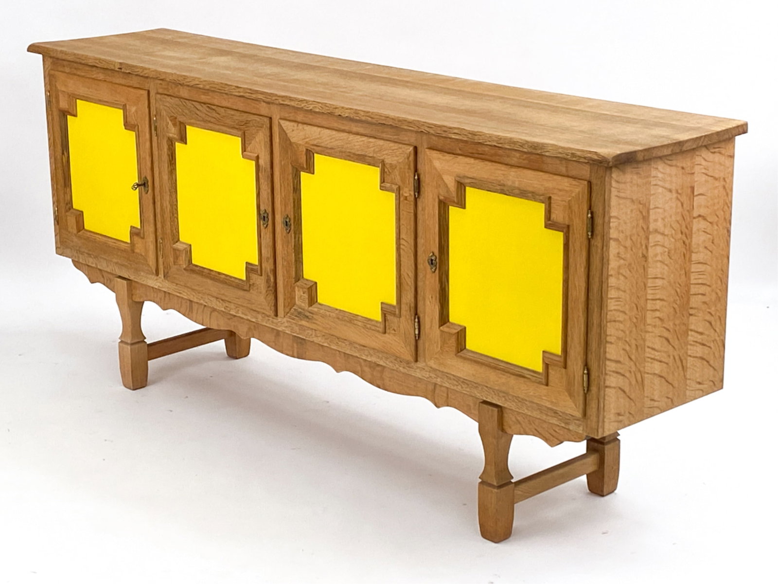 DANISH KJERNULF STYLE OAK SIDEBOARD: Unsigned. Danish. c. 1970. Includes key. Dimensions: H 36" x W 80" x D 17.75" Condition: Showing overall light normal signs of age and use. Base may not be original. D018
