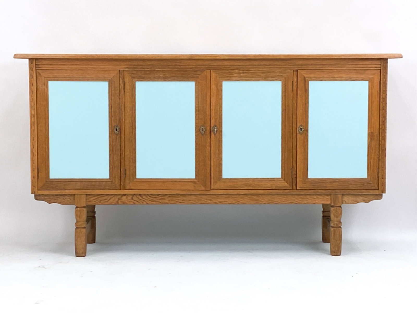 DANISH KJERNULF STYLE OAK SIDEBOARD: Danish. c. 1970. Dimensions: H 41.25" x W 77.25" x D 19.25" Condition: Base may not be original. Underside has been painted. Light normal signs of use. D020