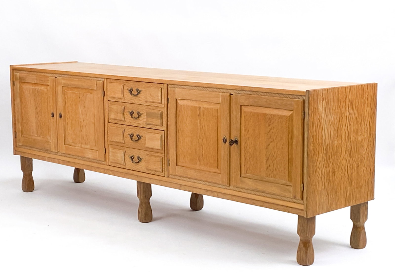 DANISH KJAERNULF STYLE OAK SIDEBOARD: Danish. c. 1970. Dimensions: H 29.75" x W 86.75" x D 19" Condition: Couple light marks consistent with age. D024
