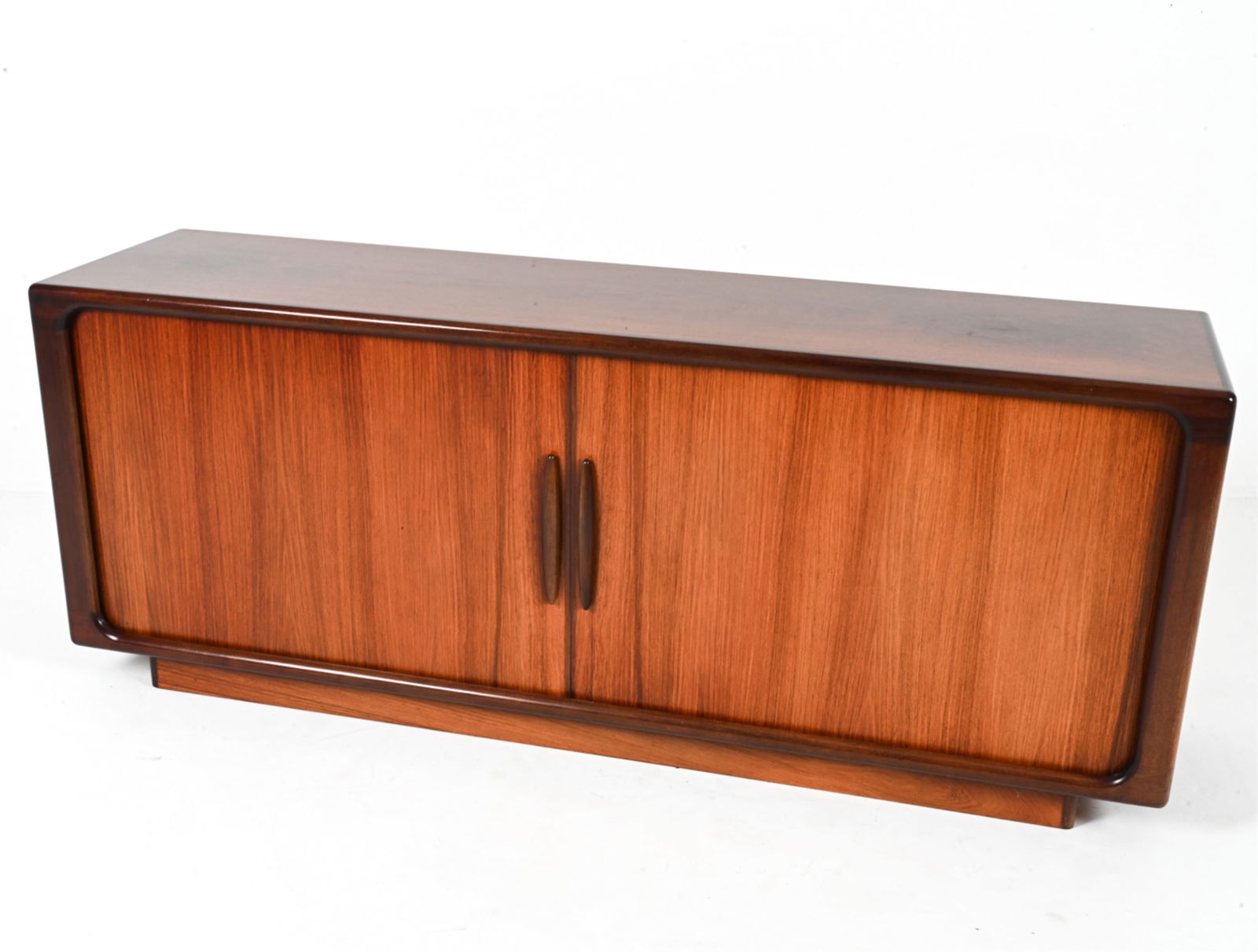 ROSEWOOD SIDEBOARD BY DYRLUND C.1960'S: With tambour doors. Adjustable shelves with central shelves, one lined with green felt. Danish. Dimensions: H 30" x W 75" x D 19". Condition: Minor nicks and scuffs, presents very well overall. PG087