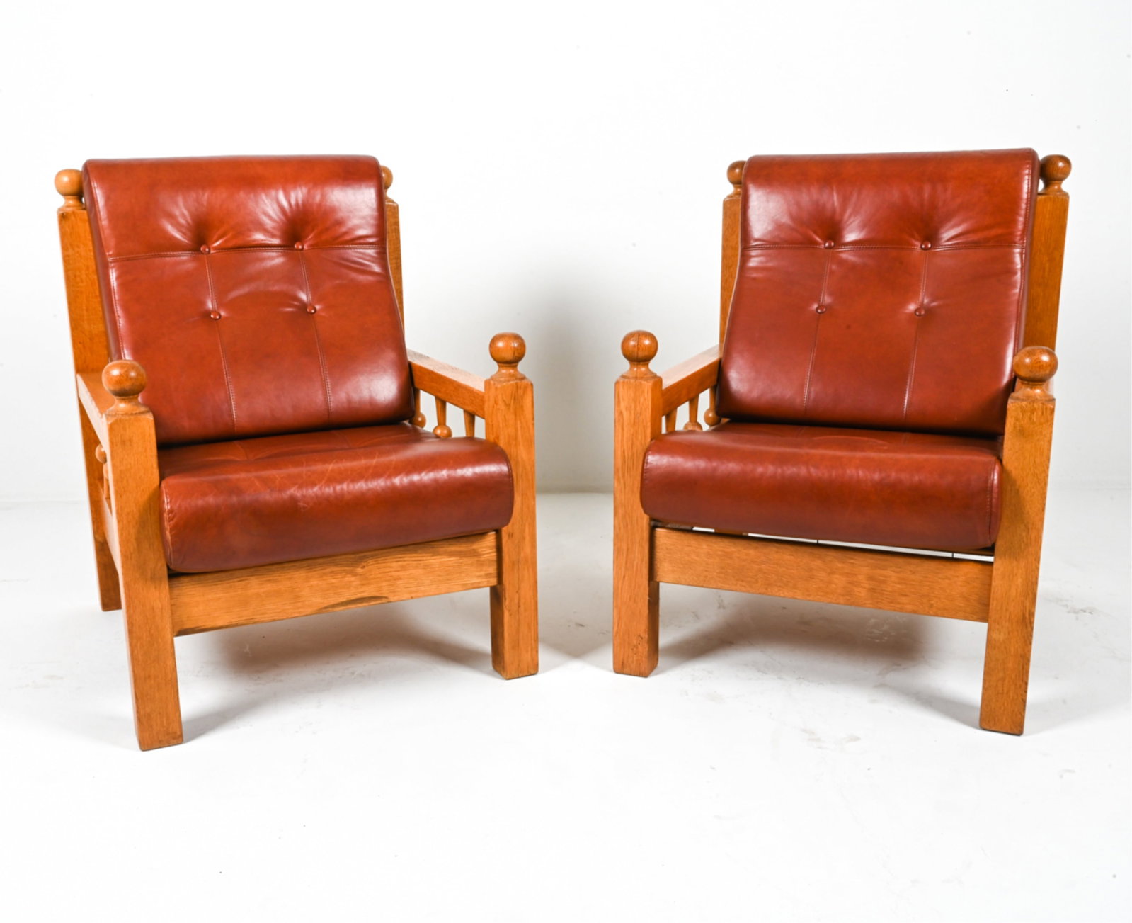 (2) DUTCH OAK AND LEATHER BRUTALIST LOUNGE CHAIRS: Made by Oisterwijk. Dimensions: H 40.75" x W 29.25" x D 33" x SH 18". Condition: Some faint discolored scuffs to leather. Wear consistent with age and use. PG076