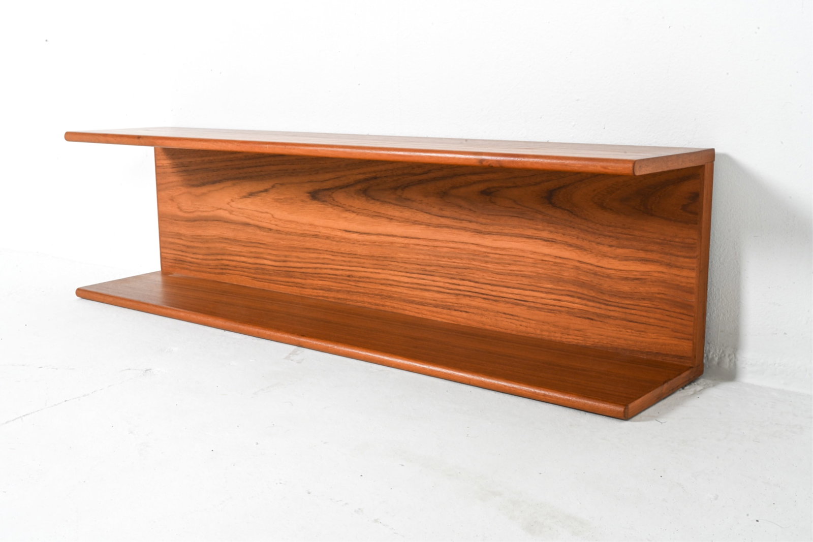 DANISH TEAK WALL SHLEF BY PEDERSEN C.1960'S: Dimensions: H 10.75" x W 39.5" x D 8". Condition: Minor nicks, some scratches on underside, discolored scuffs PG095