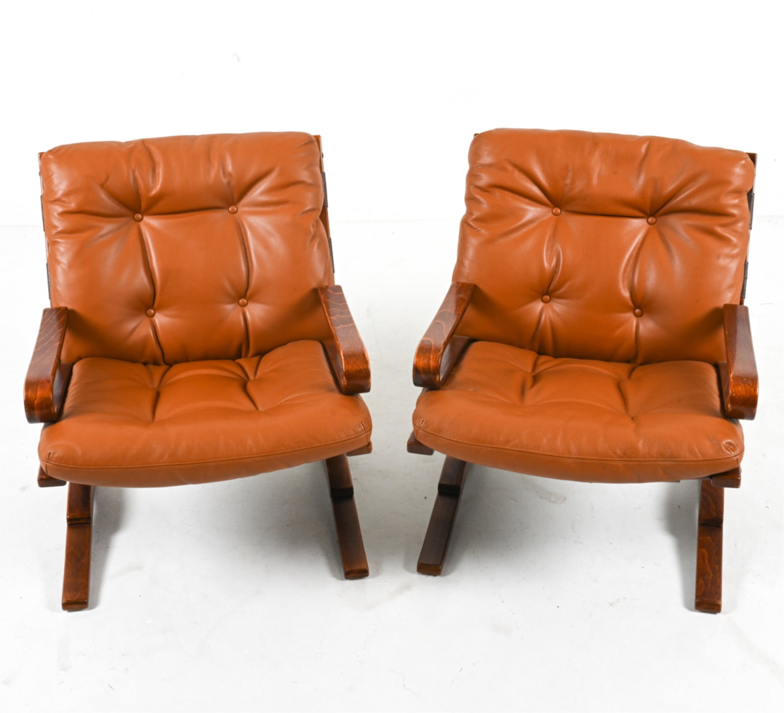 PAIR OF EINAR HOVE 'SKYLINE' LEATHER LOUNGE CHAIRS: Pair of low-back 'Skyline' lounge chairs in bentwood and leather, designed by Einar Hove for Hove Mobler. Norway, circa 1960's. Dimensions: H 31.75" x W 26" x D 31". SH 17.5". Condition: Wear to venee