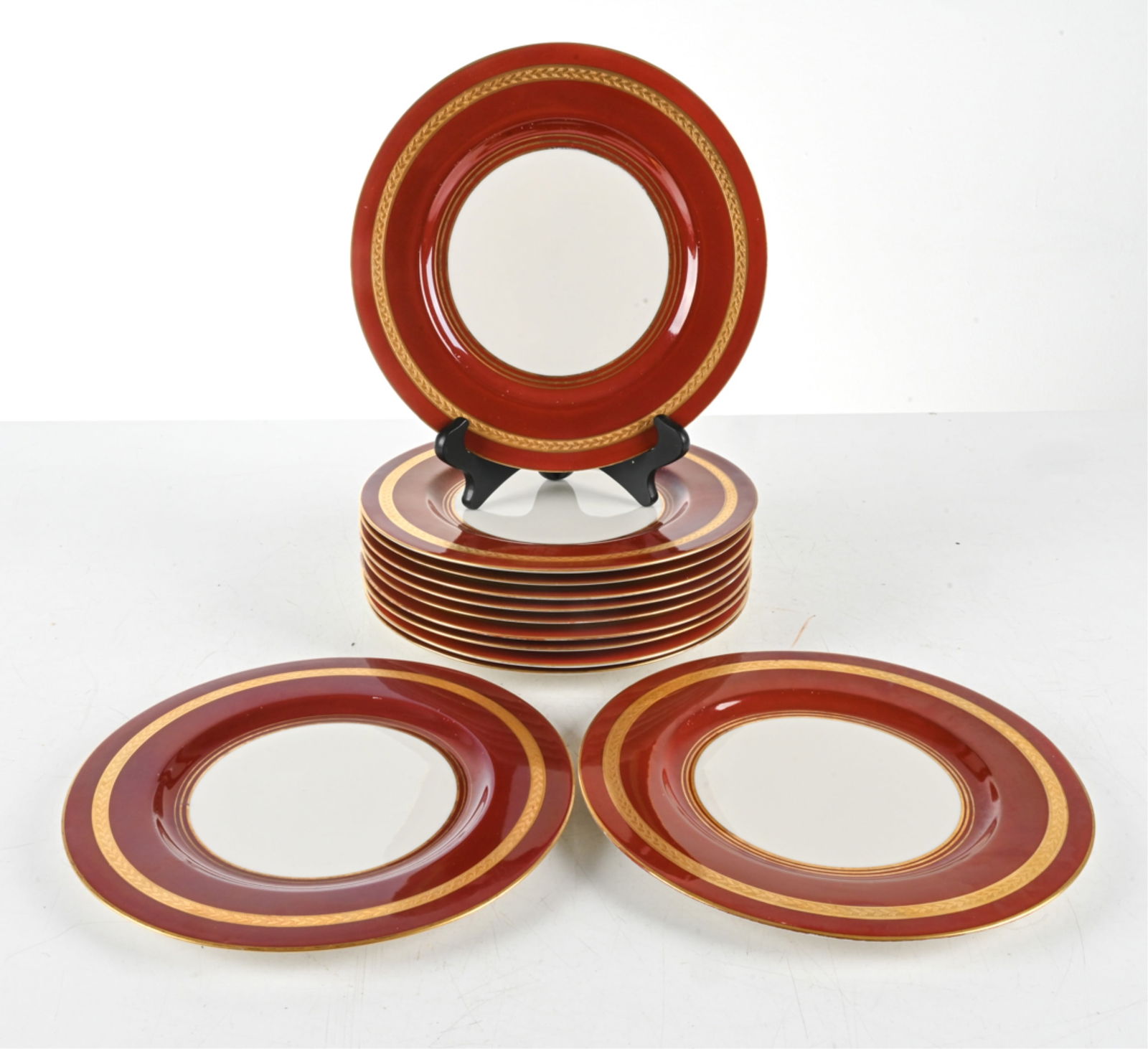 (12) HAVILAND PORCELAIN DINNER PLATES: By Theodore Haviland, New York. Red with gilded accents. Dimensions: Dia. 10.75". Condition: Minor scuffs to finish on some.