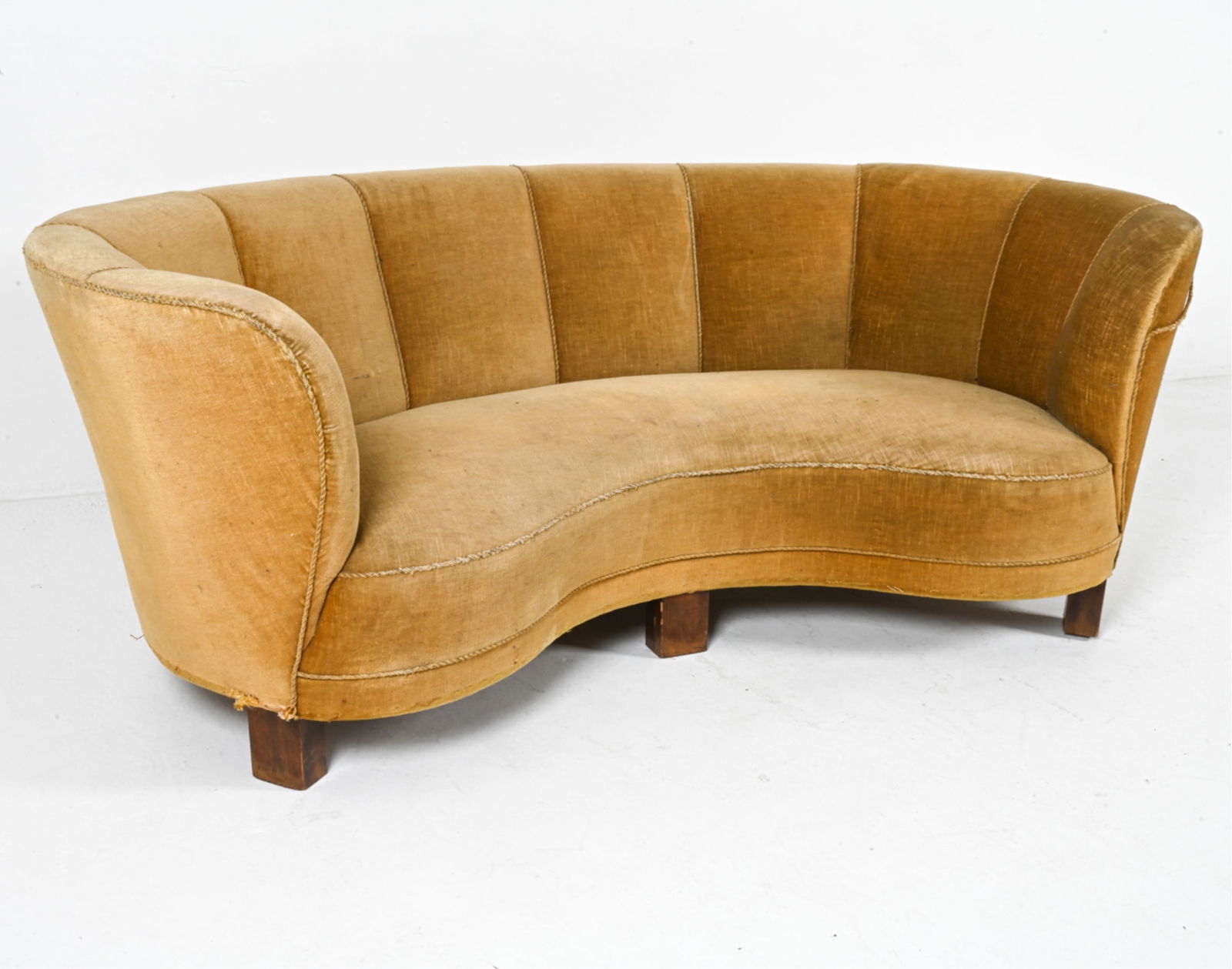 DANISH MID-CENTURY MOHAIR BANANA SOFA, C.1960'S: Olive toned mohair with fabric trim. Dimensions: H 23.75" x W 77" x D 40" x SH 14.5". Condition: Trim is loose in places, some tears to upholstery, fading. Great candidate for restoration. Wear consis