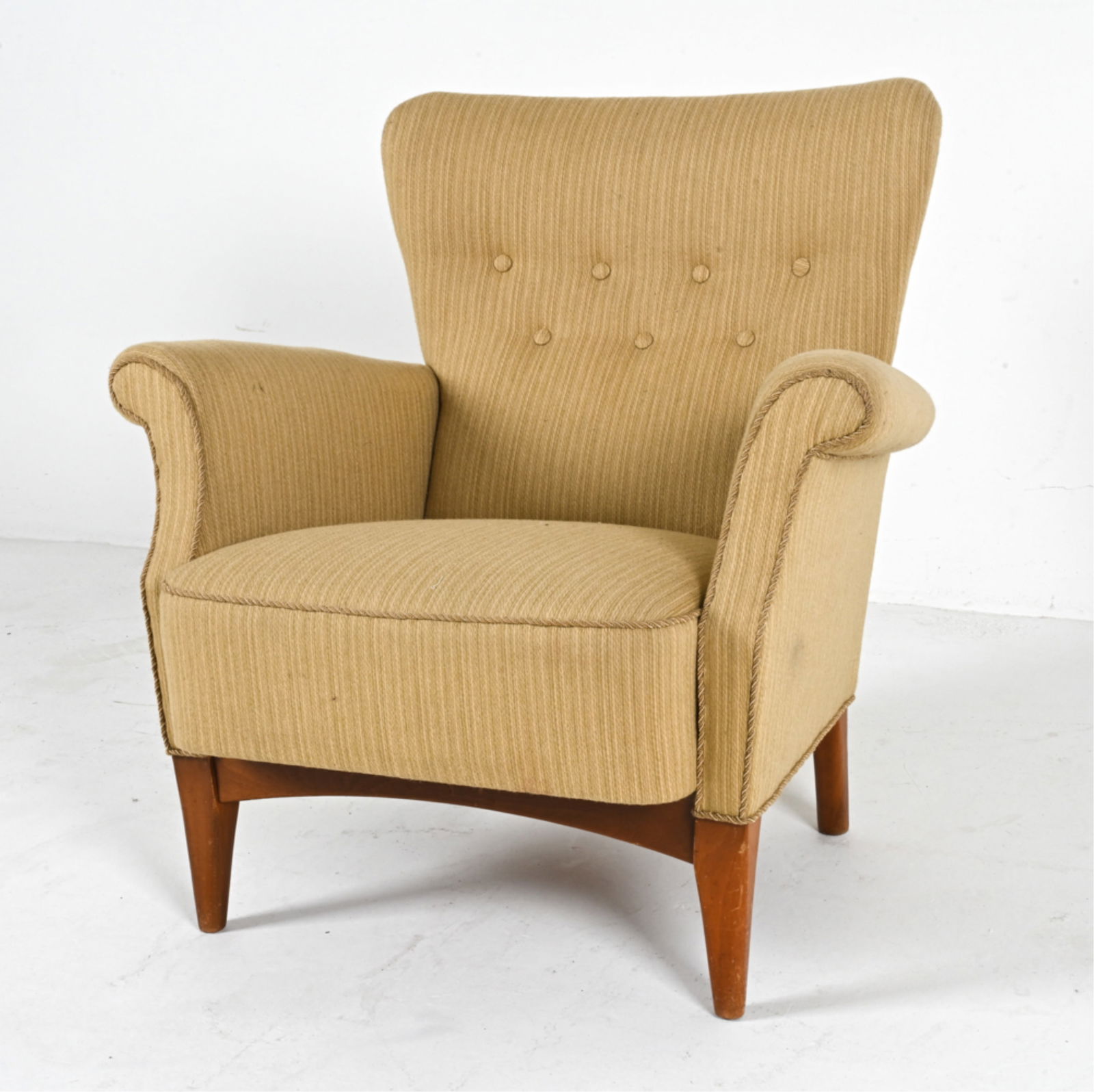 DANISH LOUNGE CHAIR IN MANNER OF FRITS HENNINGSEN: From 8000 series. Upholstered in wool with fabric trim. Beech legs. Circa 1960's. Dimensions: H 32" x W 31.5" x D 22" x SH 16.25". Condition: Some wear to fabric, scuffs and dings to legs. Wear consis