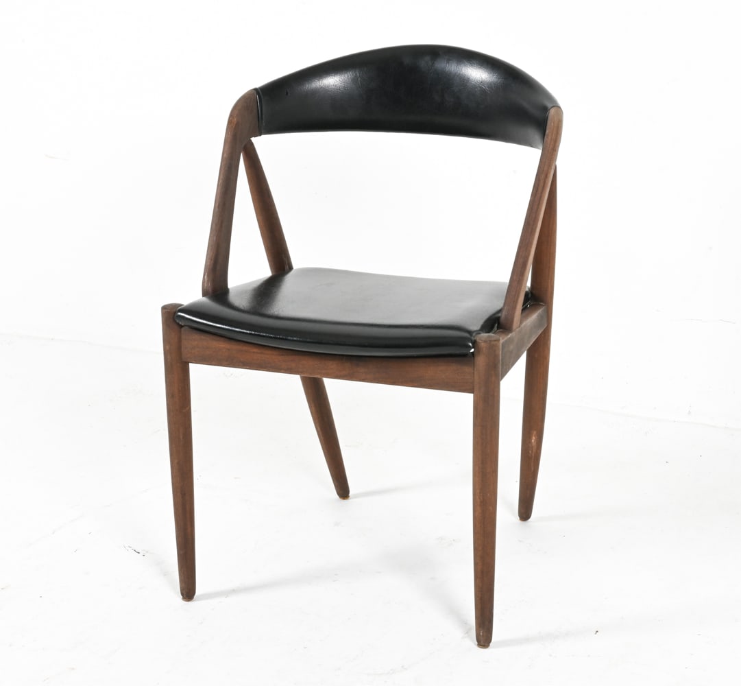 TEAK AND VINYL DINING CHAIR BY KAI KRISTIANSEN: Iconic model No.31. Denmark, circa 1970's. Dimensions: H 29.5" x W 20" x D 18.25" x SH 17.5". Condition: Minor scuffs to wood, material.