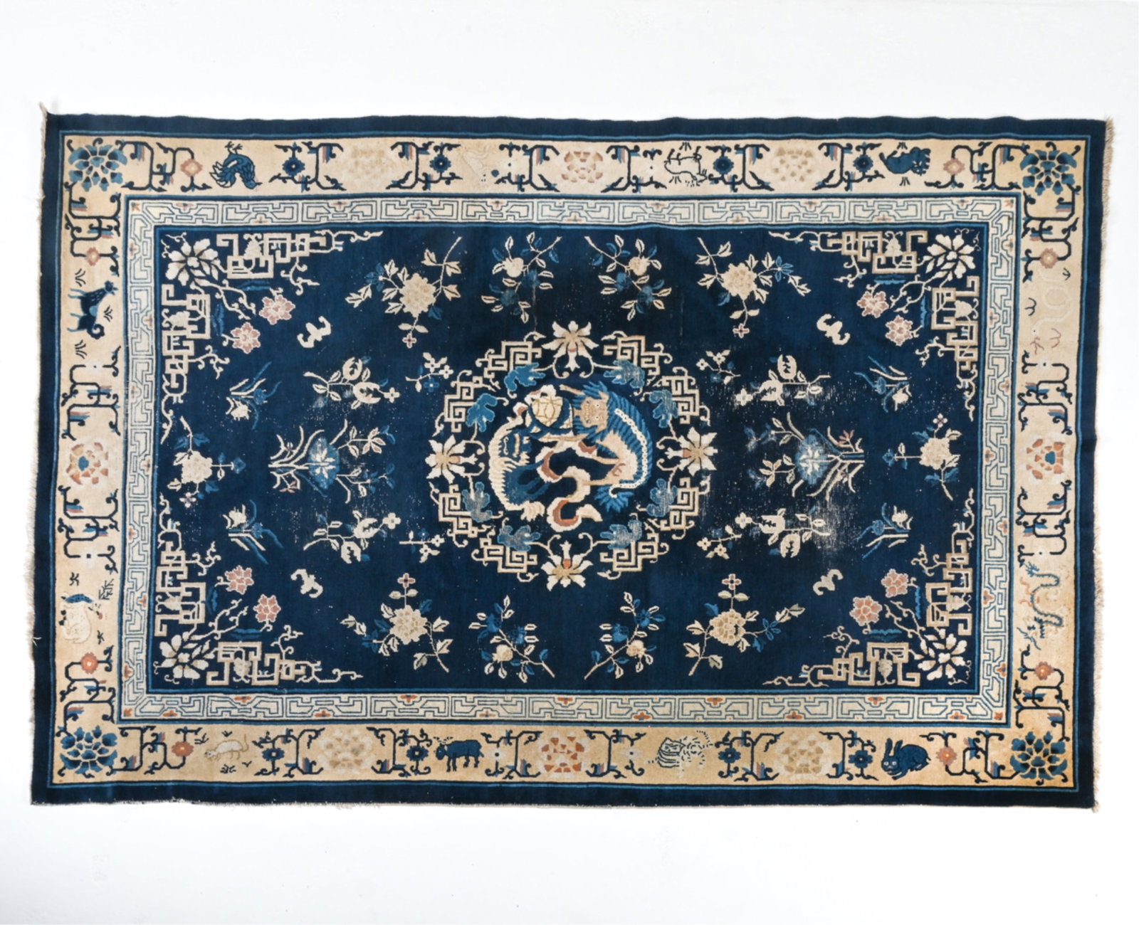 ANTIQUE ART DECO CHINESE RUG, C.1920'S: With blue decoration featuring several animals. Dimensions: H 120" x W 83". Condition: Sun fading and minor surface soiling.