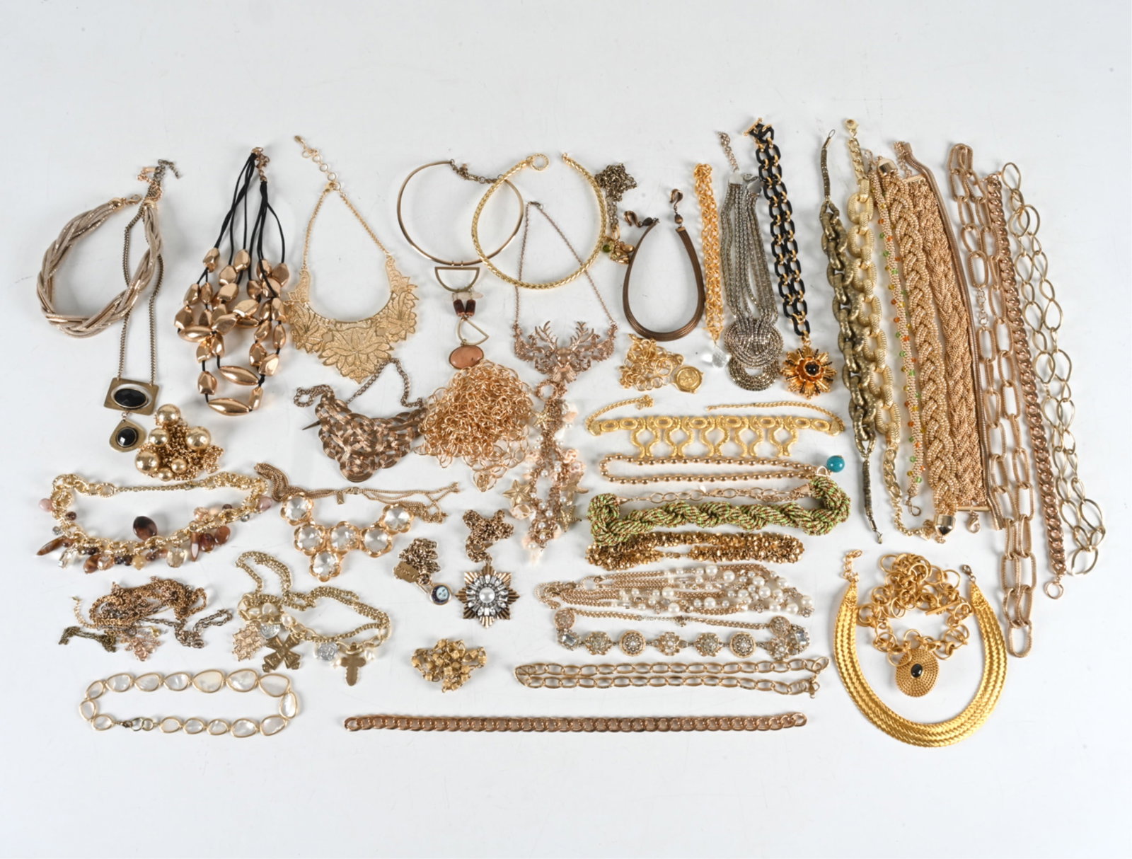 GROUPING OF GOLD TONE COSTUME JEWELRY: Large grouping of gold toned costume jewelry. Brands include Express, Taken, Mira, Juliet & Co, Amrita Singh, Julie Vos, others. Contemporary. Condition: Minor signs of wear, no issues to note.