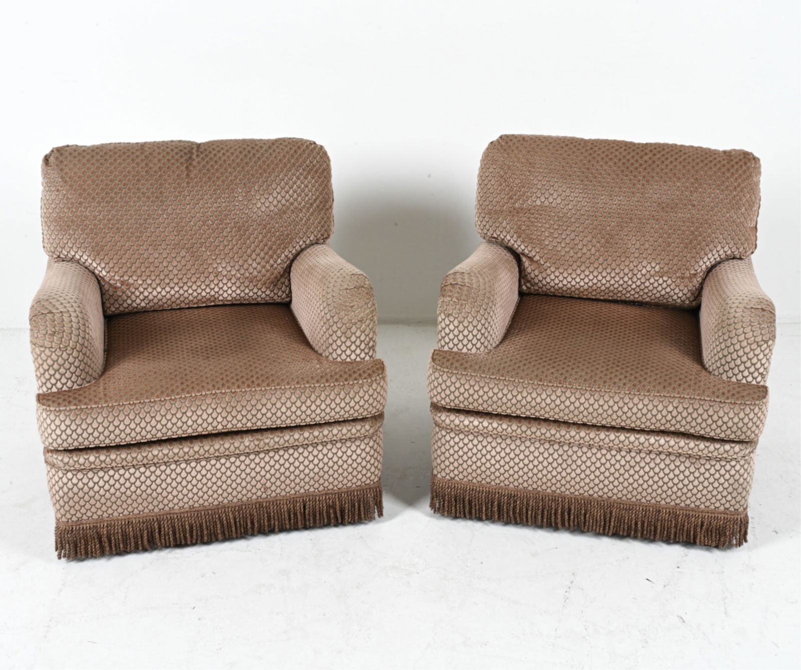 (2) VELVET ARMCHAIRS, CIRCA 1970'S: Textured velvet upholstery with fabric fringes. Dimensions: H 30" x W 30.25" x D 31.5" x SH 16.5". Condition: Minor fading and surface soiling to fabric, some spots of wear and threading. Wear consist