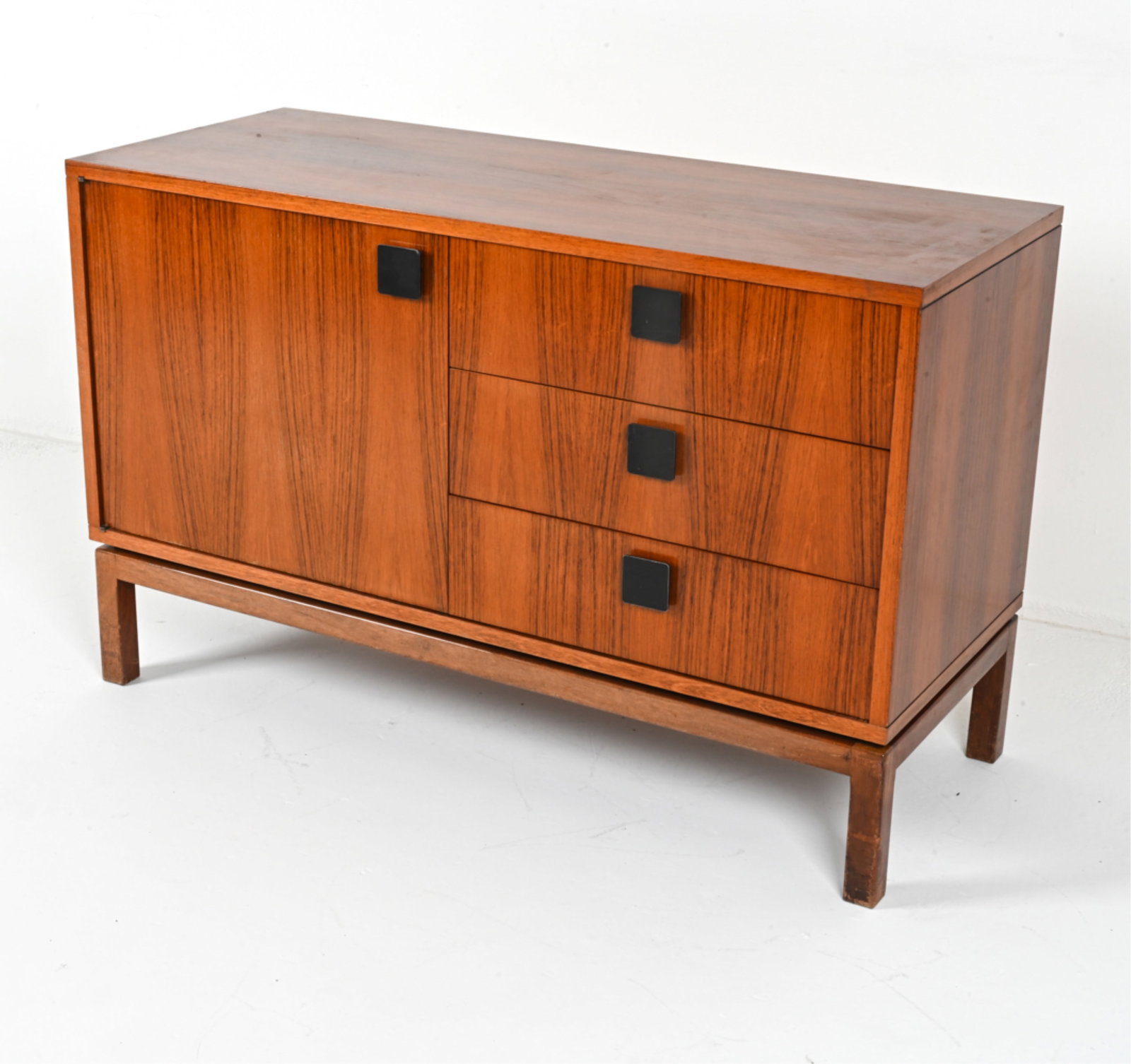 MID-CENTURY DANISH ROSEWOOD CABINET: Rosewood veneer with square-shaped iron cabinet pulls. Circa 1970's. Dimensions: H 30" x W 47.25" x D 19". Condition: Minor chips to veneer, light scuffs and scratches, wear consistent with age and us