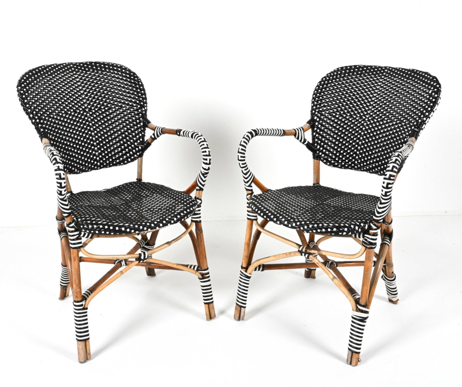 (2) FRENCH BISTRO CAFE ARM CHAIRS: Bistro style. With woven vinyl upholstery and accents. Circa 1970's. Dimensions: H 34.25" x W 19.25" x D 22" x SH 16.5". Condition: Wear to wood on arms, legs, around segments. Some scuffs to vinyl. W