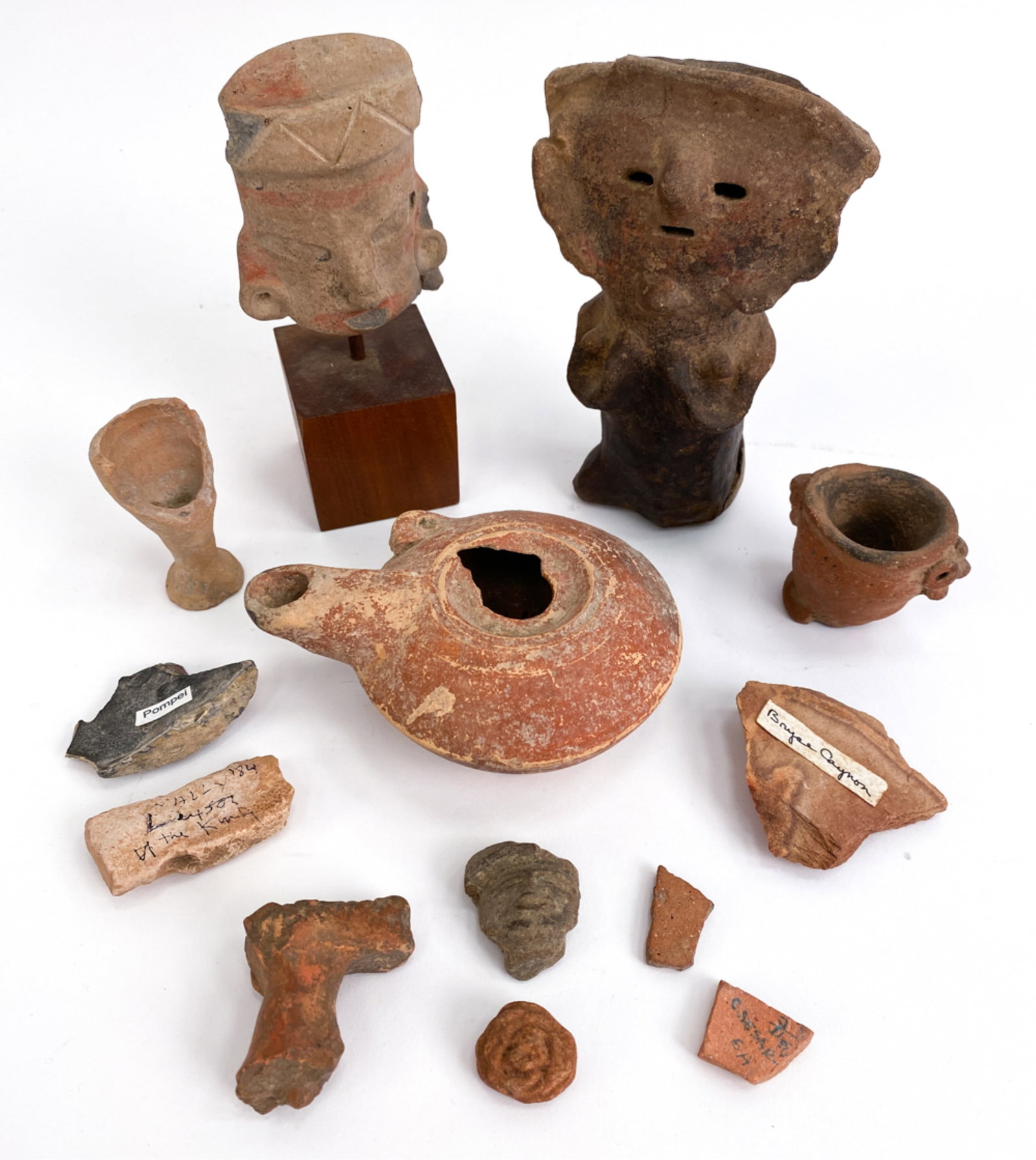 GROUPING INCL. PRE-COLOMBIAN POTTERY: Variety of pre-colombian artifacts from different locations. some are only fragments. Dimensions: (Tallest) H 6.25" x W 2.5" x D 2" Condition: Some with damages, some may be lacking pieces. Burial sur
