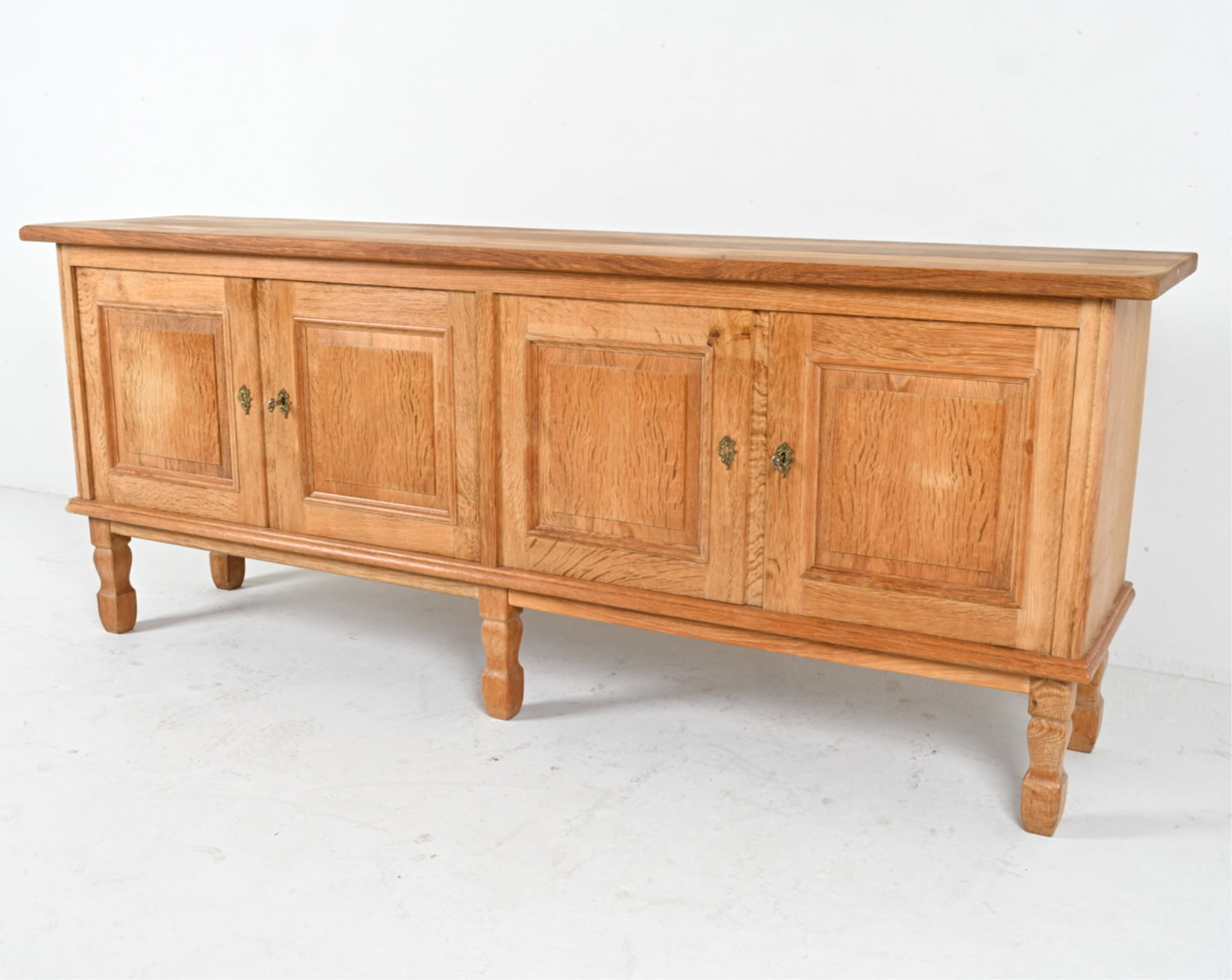 MANNER OF KJAERNULF DANISH OAK SIDEBOARD: (2) keys included. Circa 1970's. Dimensions: H 32" x W 80.5" x D 18" Conditions: Light surface wear consistent with age and use, DMG018