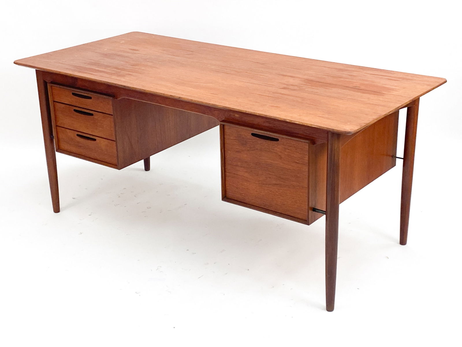 ARNE VODDER STYLE TEAK EXECUTIVE DESK, C. 1960'S: Large desk with one large drawer and three small drawers. In the style of Arne Vodder, unsigned. Dimensions: H 28" x W 65" x D 29.75" Condition: Finish wear including a 18" scratch. Normal wear consis