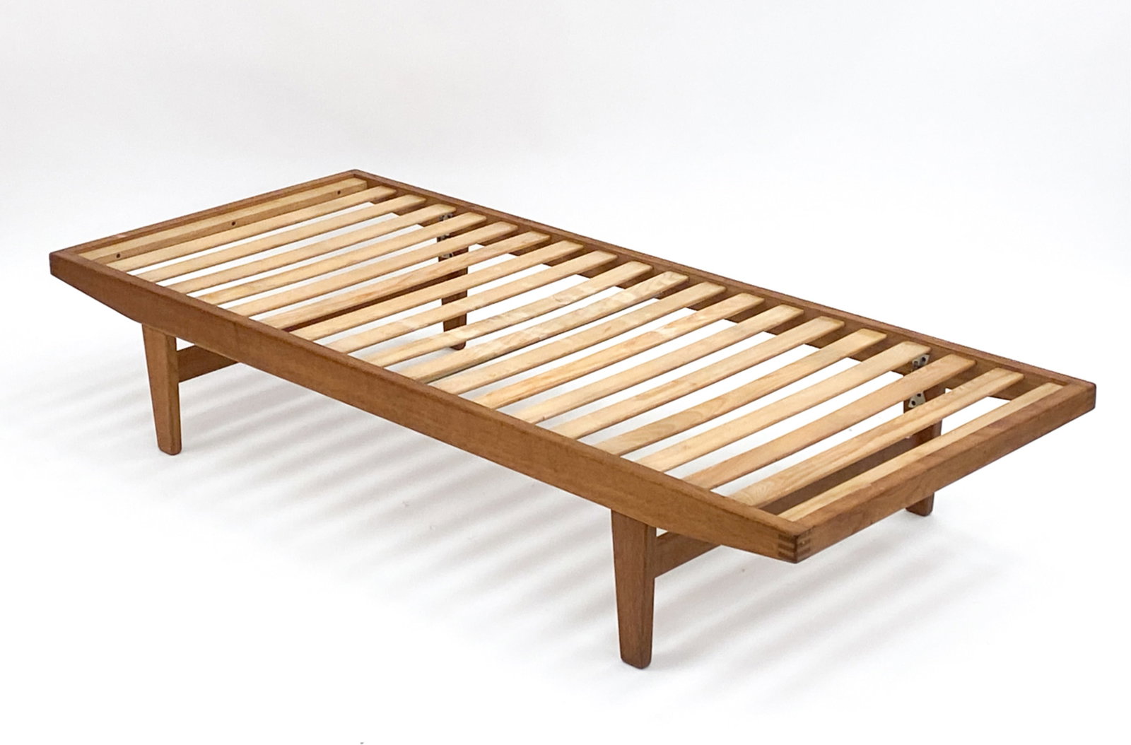POUL M. VOTHER FOR FDB OAK DAYBED, C. 1970'S: Stamped underneath first slat. No mattress included. Dimensions: H 13.5" x W 74.5" x D 31.5" Condition: Wear to slats, indents, finish wear, all consistent with age and use. E152