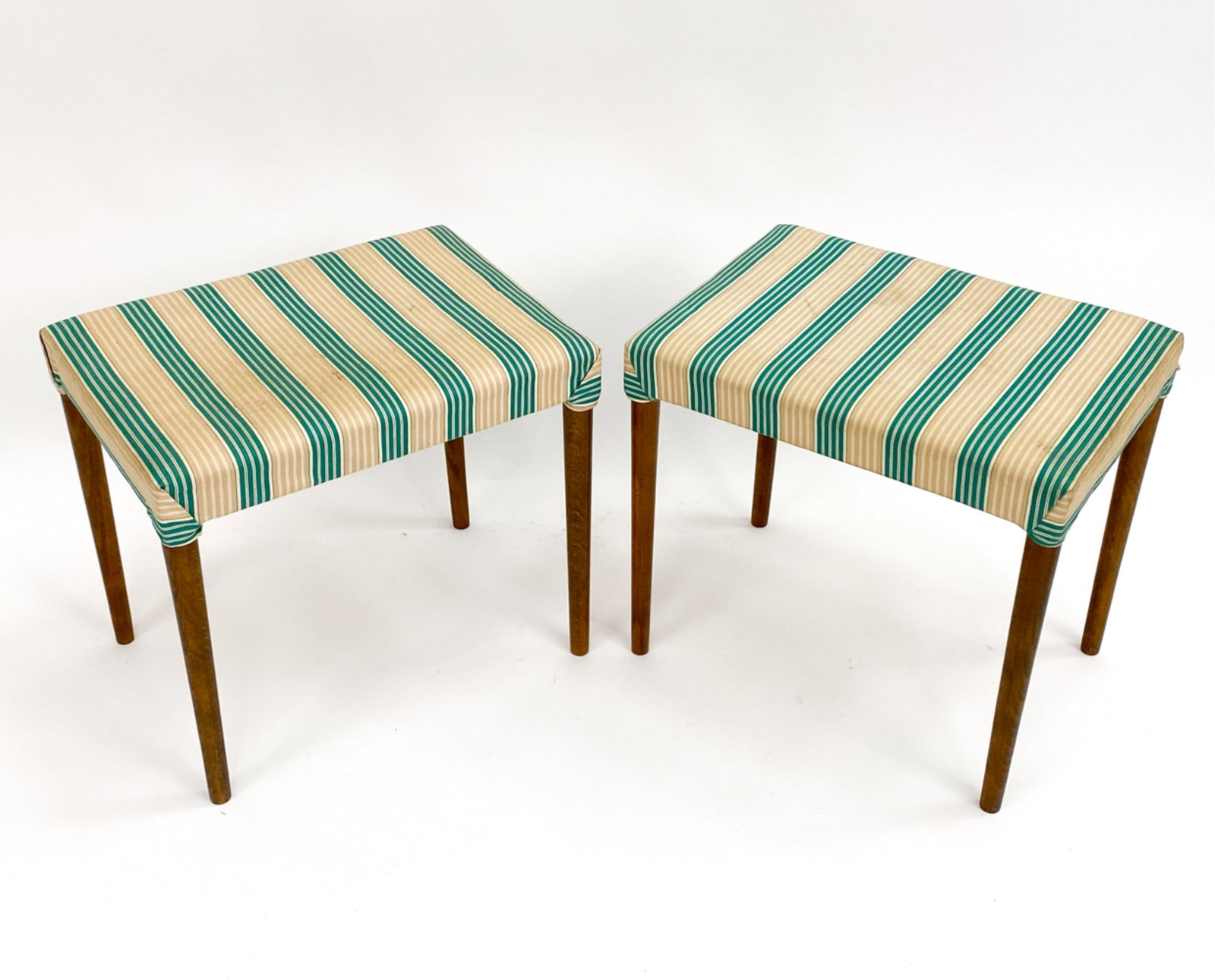PAIR OF DANISH MID-CENTURY TEAK FOOTSTOOLS: Pair of teak and striped fabric footstools. Apparently unmarked. Fabric appears to be original. Circa 1960's. Dimensions: H 17.5" x W 19.5" x D 14" Condition: Few stains to underside and to fabric. Li