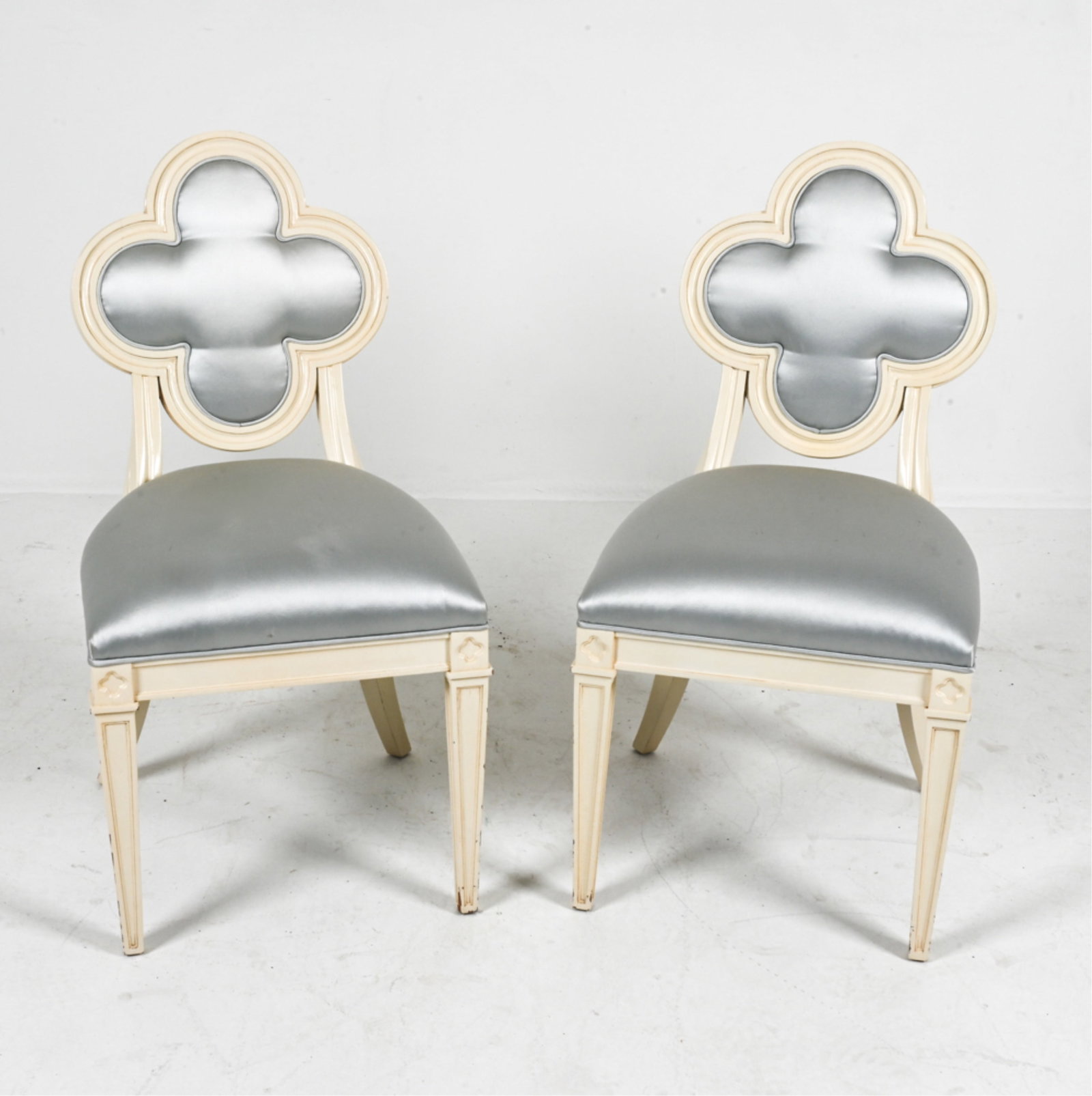 (2) SCULPTURAL ALEXANDRA CHAIRS BY SUZANNE KASLER: Painted and carved with clover-shaped seat backs. Fabric upholstered seats and backs. Contemporary. Dimensions: H 34" x W 18" x D 16" x SH x 18". Condition: Minor nicks and rubs to painted finish.