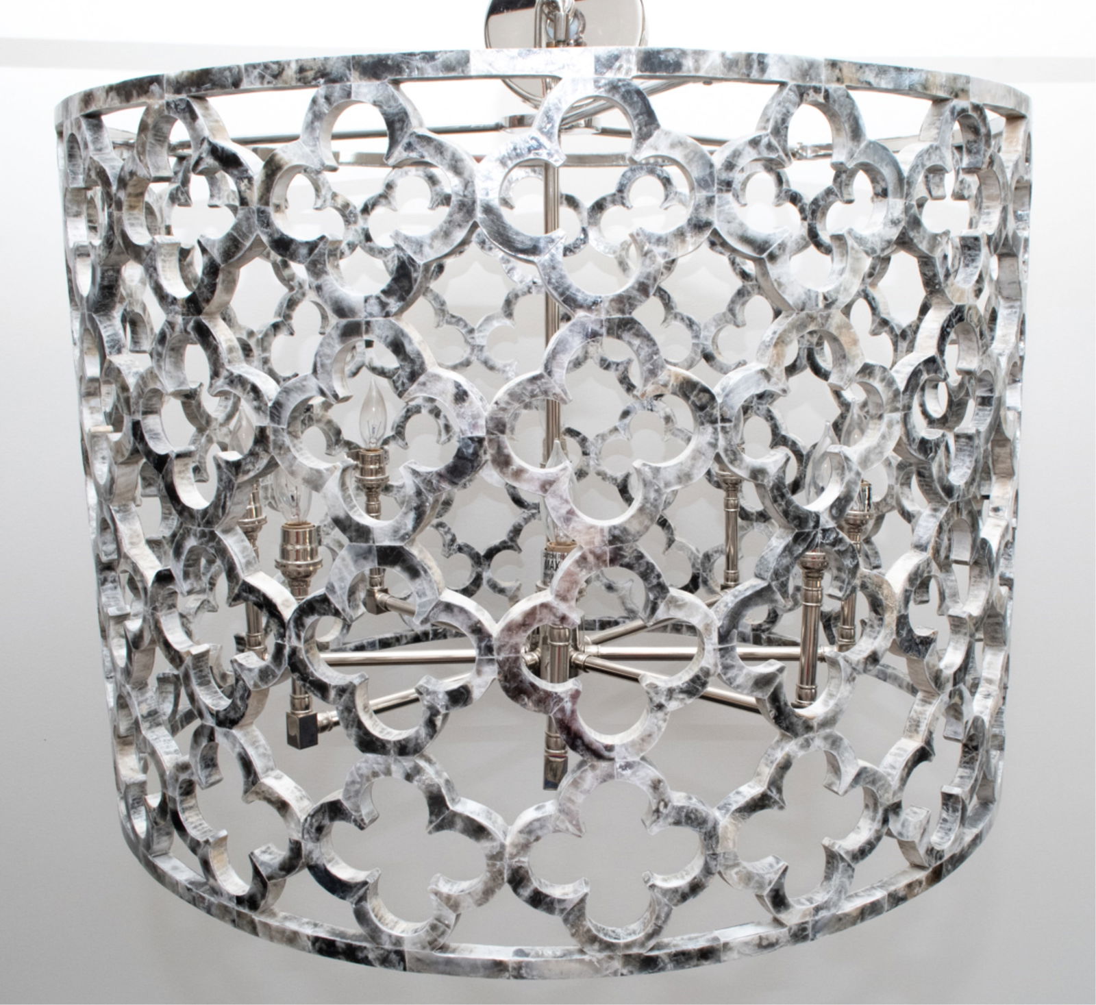 'ASILAH' DRUM CHANDLIER FOR IRONIES: With quatrefoil cut-out design in drum shape, with natural shell veneer on iron. 8-light, candelabra sockets, canopy, and 3' of chain included. Contemporary. Dimensions: H 20.5" x Dia. 28". Condition: