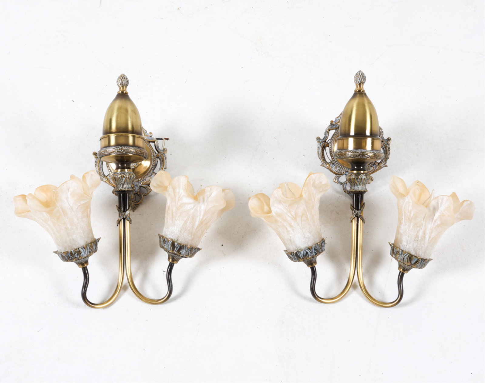 (2) BRASS AND FLORAL GLASS SHADE SCONCES: Brass sconces with off-white floral glass shades. Neoclassical cast designs to brass. Dimensions: H 16.5" x W 15" x D 9.75". Condition: Requires rewiring. Some surface soiling to brass, glass shades. 
