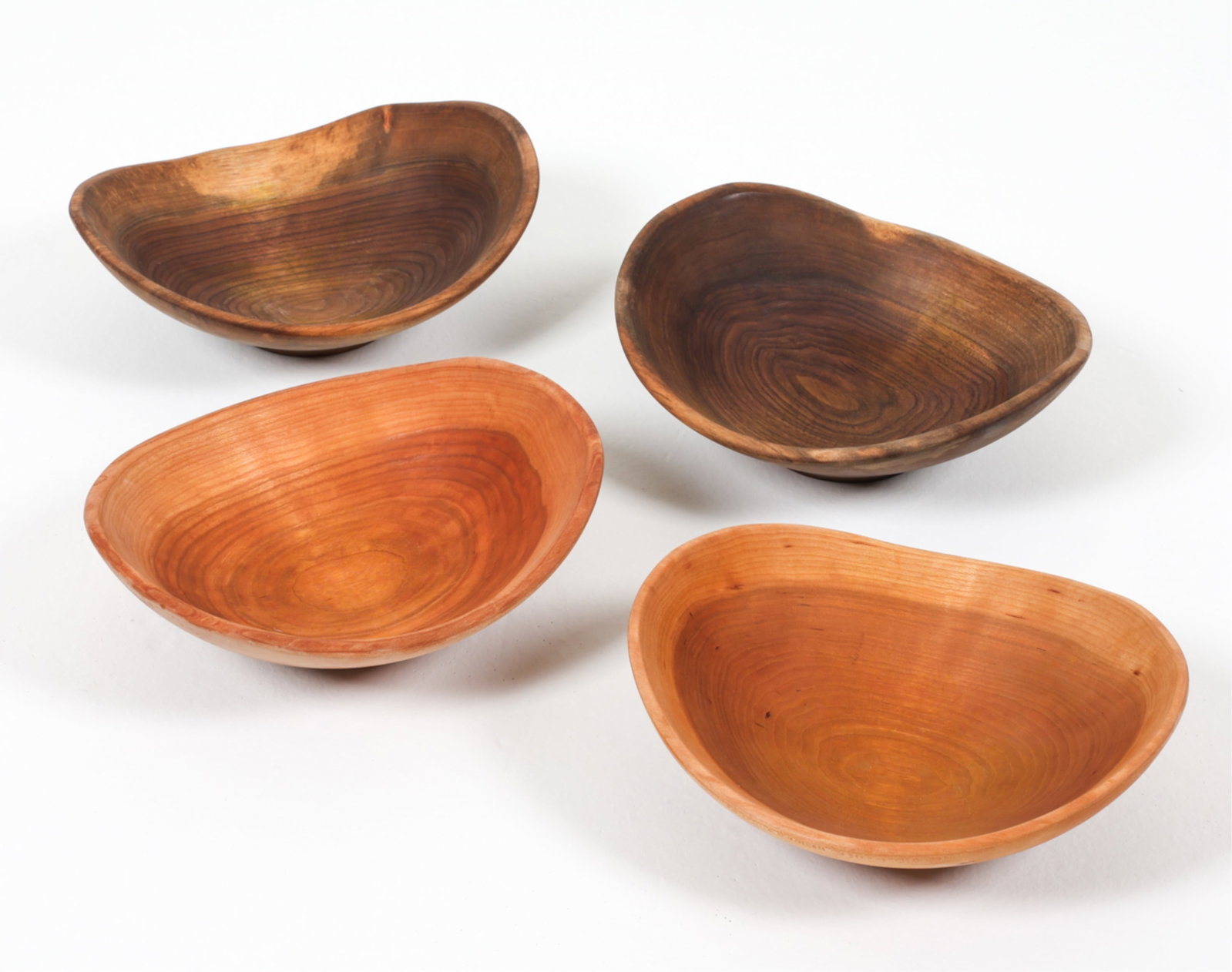 (4) CHERRY & WALNUT WOOD BOWLS BY ANDREW PEARCE: In Cherry and Walnut. Contemporary. Dimensions: Approx. W 10.5" x D 9.5". Condition: Minor signs of wear and use, some rubs.