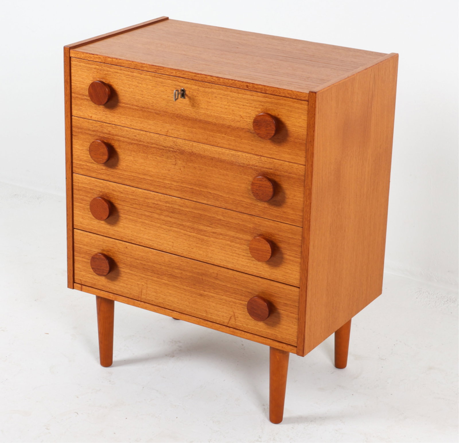 DANISH TEAK CHEST OF DRAWERS: Key included. Sculpted round drawer pulls. Circa 1960's. Dimensions: H 31" x W 25" x D 15.5". Conditions: A few dings and scratches on top, drawer fronts. Wear consistent with age and use. MAX-H120B
