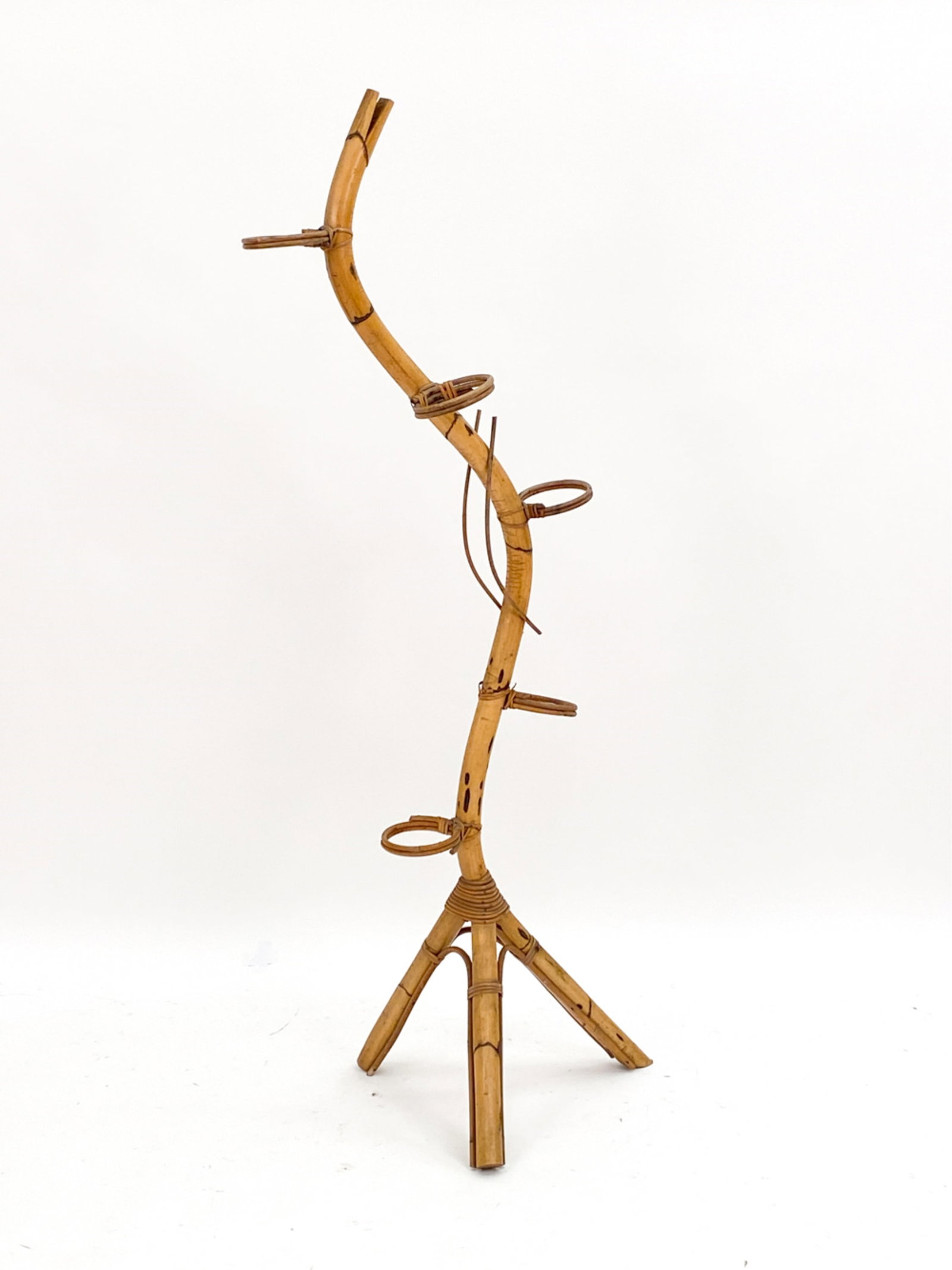 DUTCH BAMBOO SNAKE FORM PLANTER, C. 1970S: Bamboo Dutch Snake planter C. 1970s with individual hoops for smaller planters. Dimensions: H 61" x D 63" Condition: Consistent with age and use. PH033
