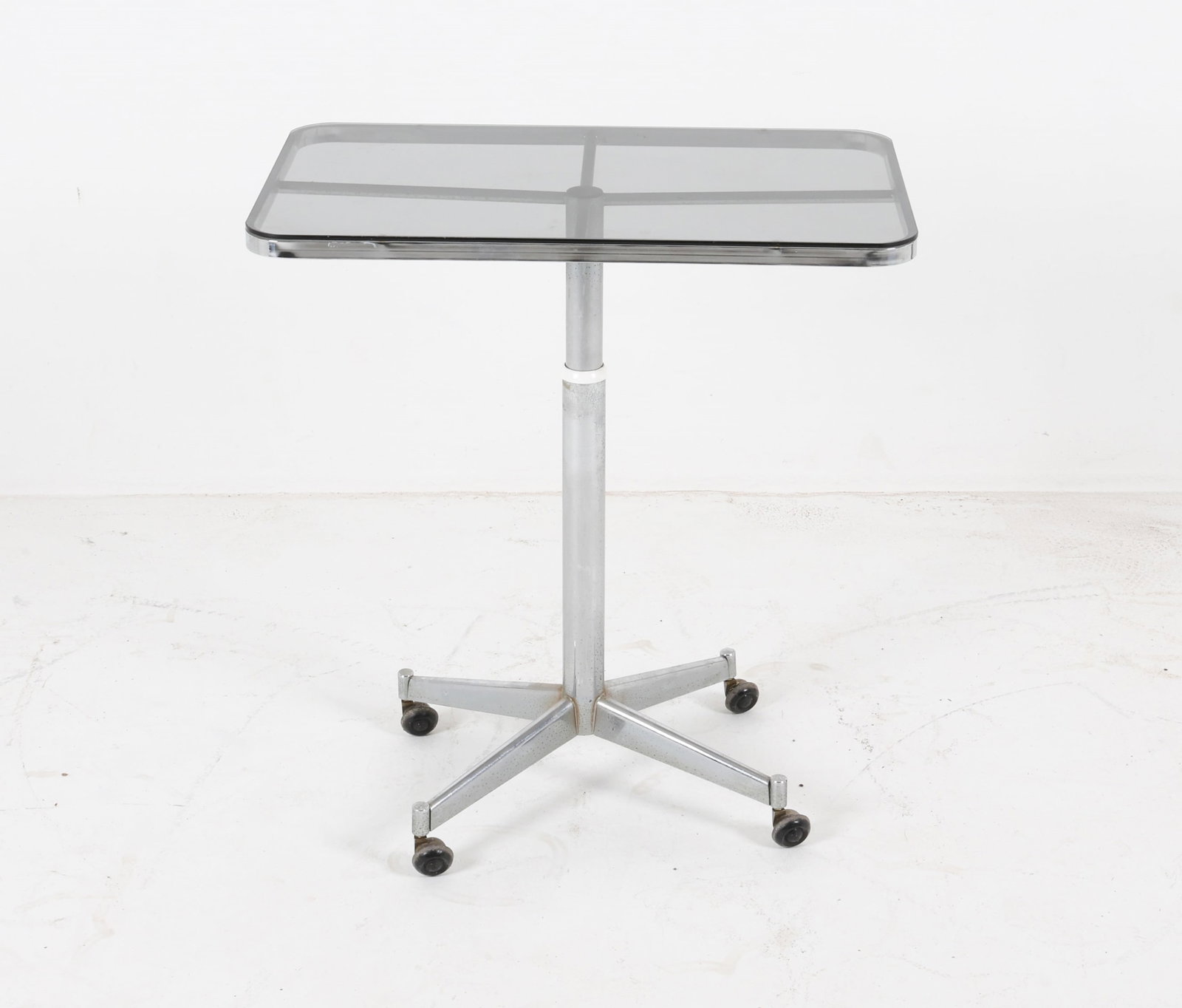 SIDE TABLE FOR ALLEGRI ARREDAMENTI: Chrome steel with glass top, adjustable height. Italy, 20th century. Dimensions: H 30.5" x W 27.5" x D 16.5". Condition: Some discoloration and oxidation to chrome. Faint surface scratches to glass. W