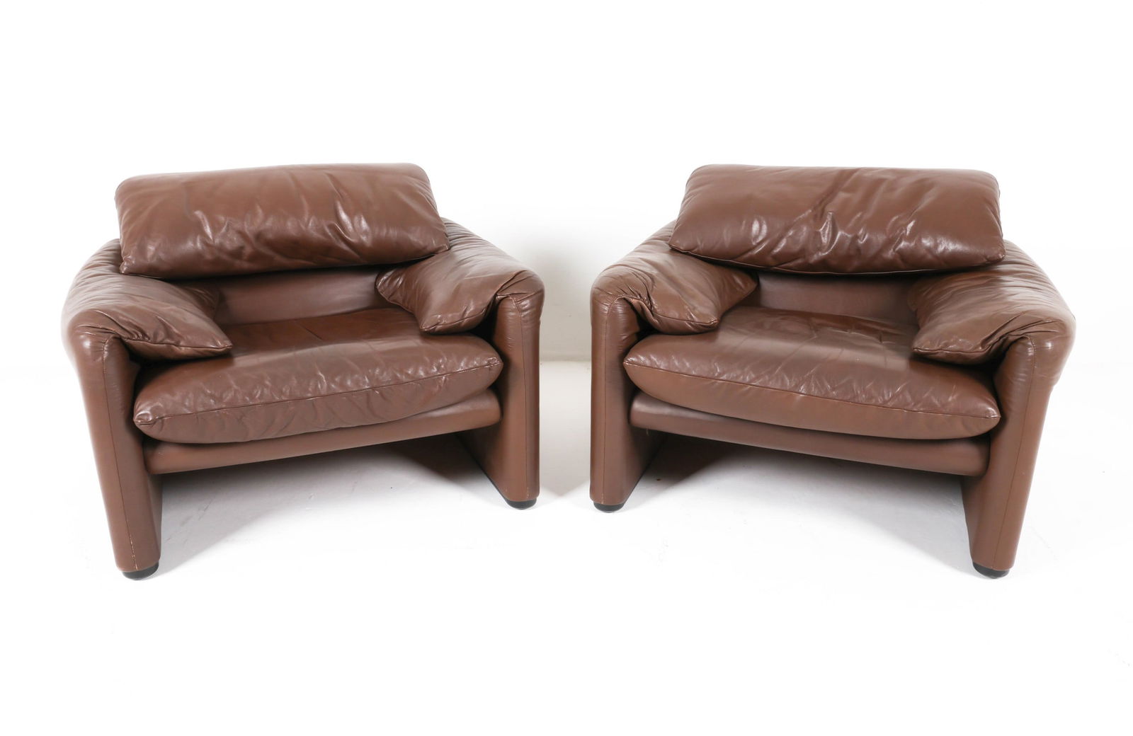 'MARALUNGA' LEATHER CHAIRS BY VICO MAGISTRETTI: For Cassina. Adjustable seat backs. Italy, Circa 1980's. Dimensions: H (lowered) 27.5" x W 38.25" x D 31" x SH 16.25". Condition: Minor signs of wear, some scuffs and surface scratches. Small scratche