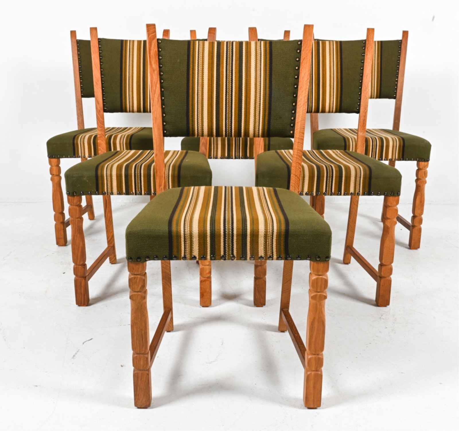(6) MANNER OF KJAERNULF OAK DINING SIDE CHAIRS: Circa 1960's. Dimensions: H 35" x W 18" x D 21" x SH 18.5". Conditions: Light wear consistent with age and use. DMG090