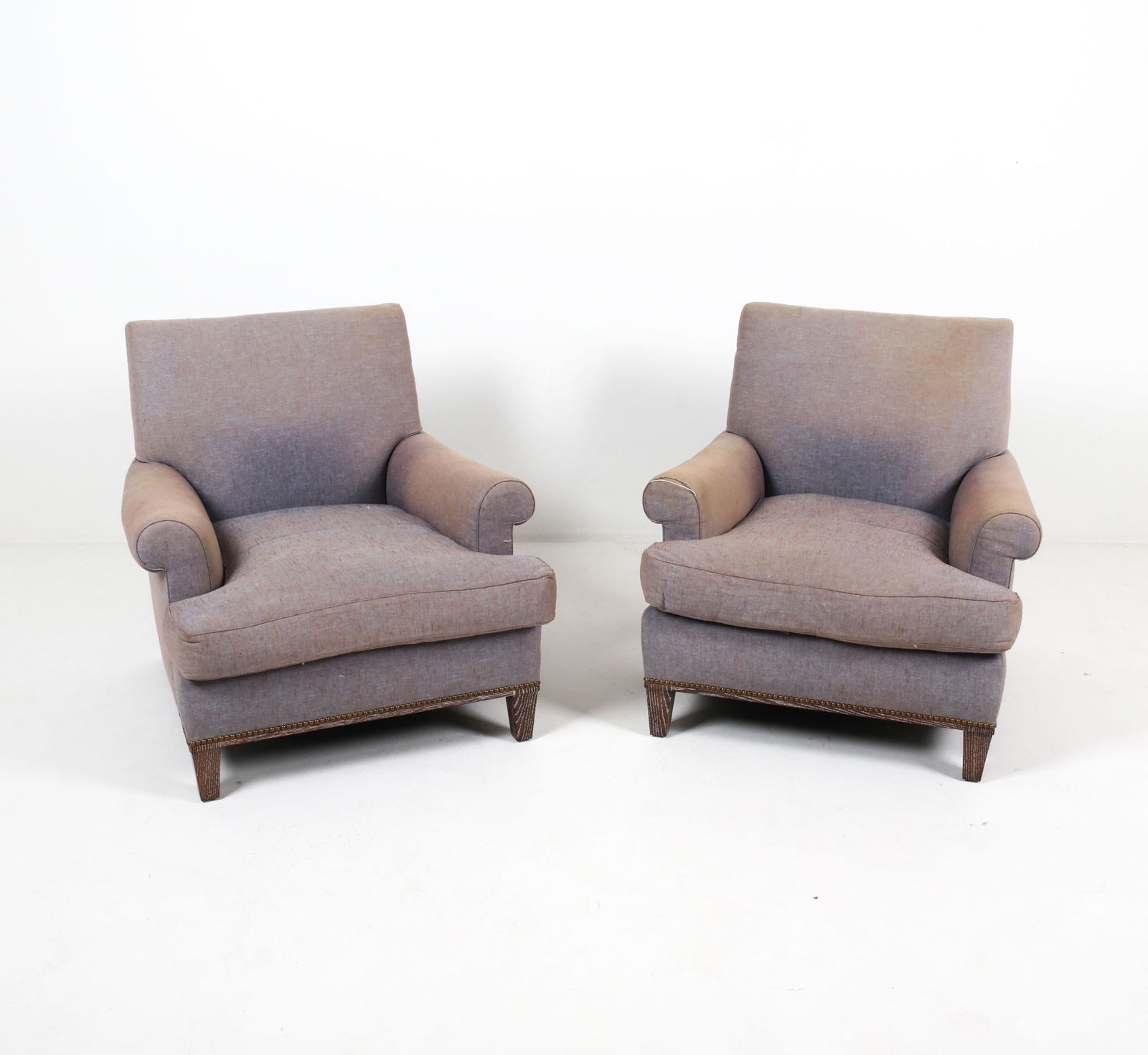 (2) OVERSIZED LOUNGE ARMCHAIRS: From Jonas. Late 20th century. Dimensions: H 31.5" x W 33.25" x D 35" x SH 17.5". Condition: Some loose fabric trim on arms, signs of wear. Faint signs of fading to fabric. Small tear on back of one a
