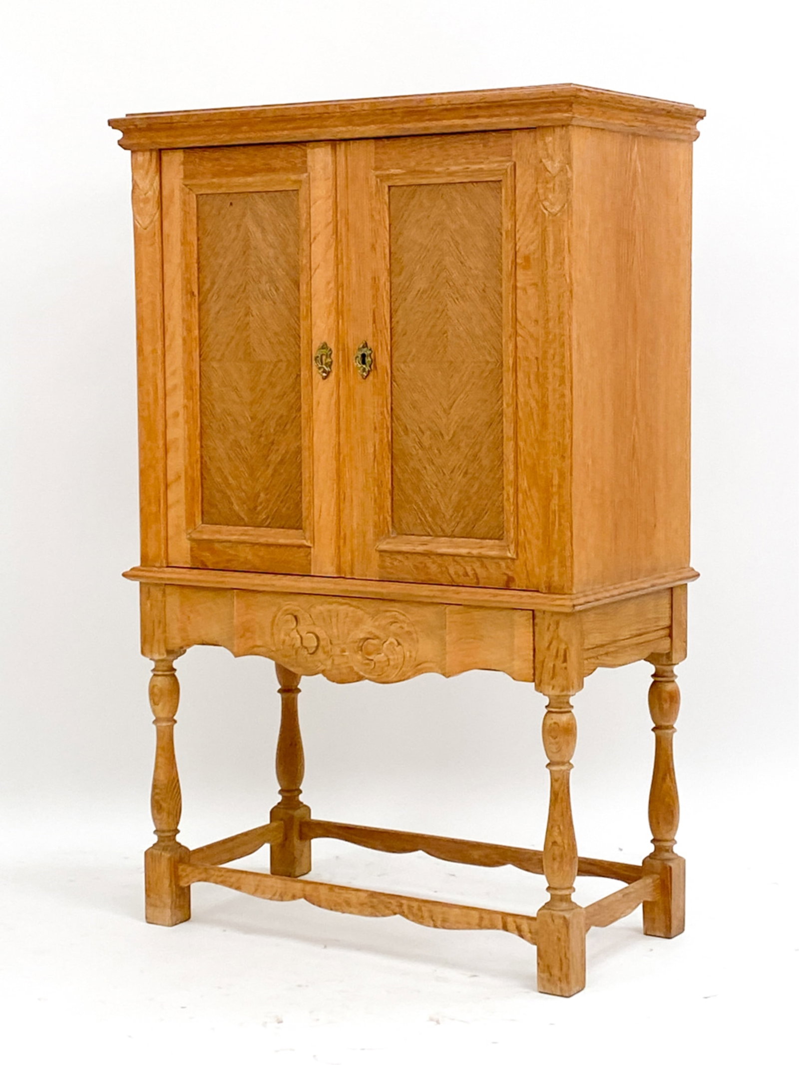 KJAERNULF STYLE OAK CABINET, C. 1970'S: Oak cabinet in the style of Henning Kjaernulf, unsigned. Includes key. Dimensions: H 42.5" x W 27.25" x D 14" Condition: Few spots of fading to top. Light finish wear including some fading to bottom o