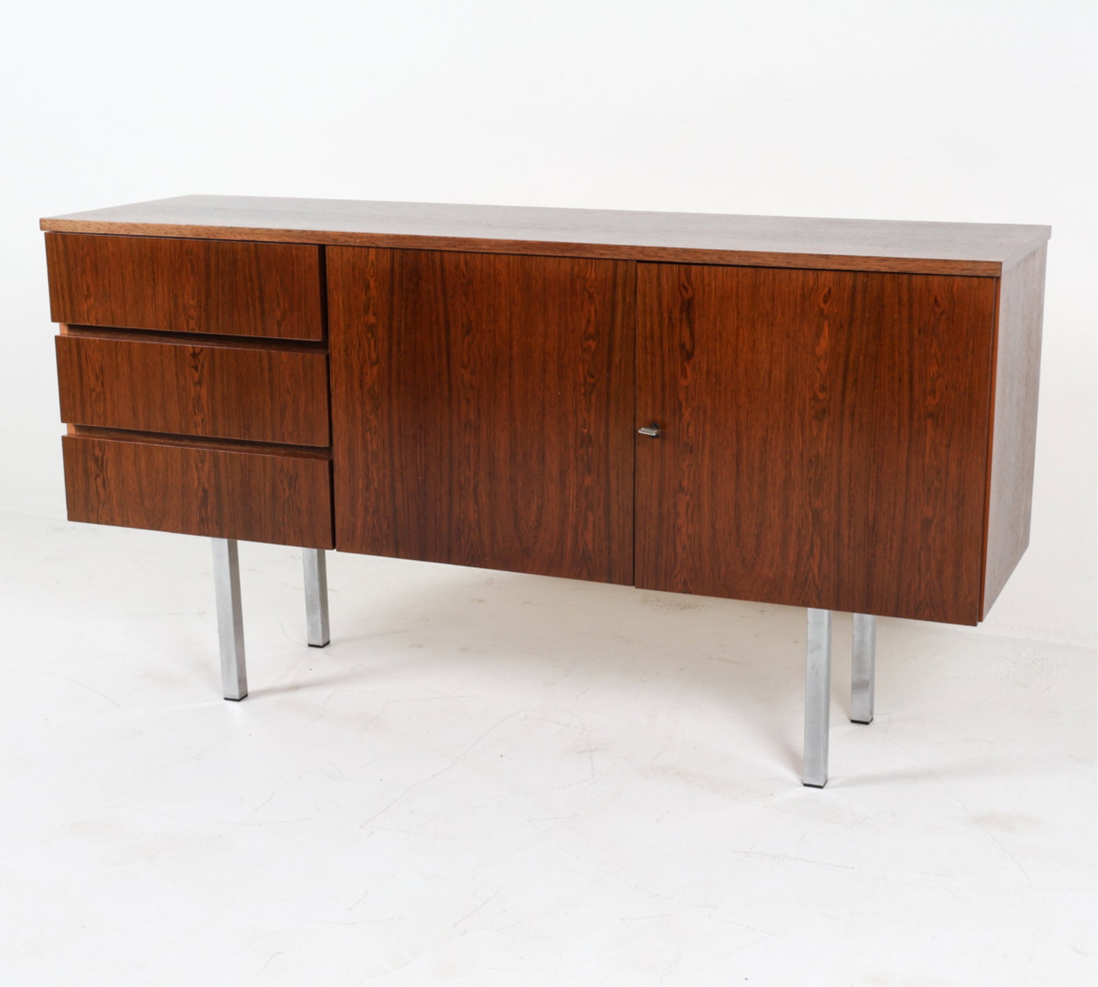 DANISH ROSEWOOD SIDEBOARD, CIRCA 1960'S.: Key included. Set on chrome legs. Dimensions: H 31.5" x W 59" x D 17.25" Conditions: Light surface wear consistent with age and use, a few scattered scuffs and rubs, PI057