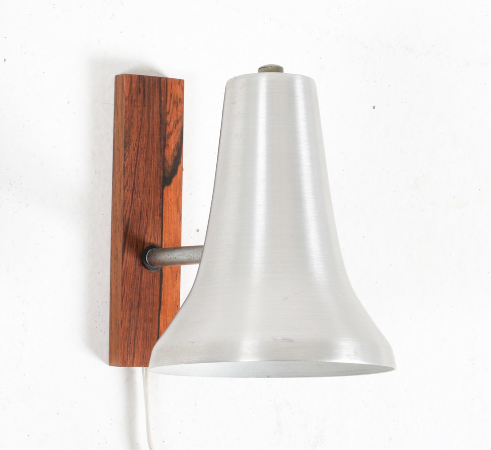 DANISH ROSEWOOD WALL SCONCE, C.1960'S: Brushed aluminum shade. Dimensions: H 5.75" x W 4.5" x D 8". Condition: Wiring untested, European plug - requires rewiring or adapter for use in the US. Minor scuffs to shade, wood. Wear consistent wi