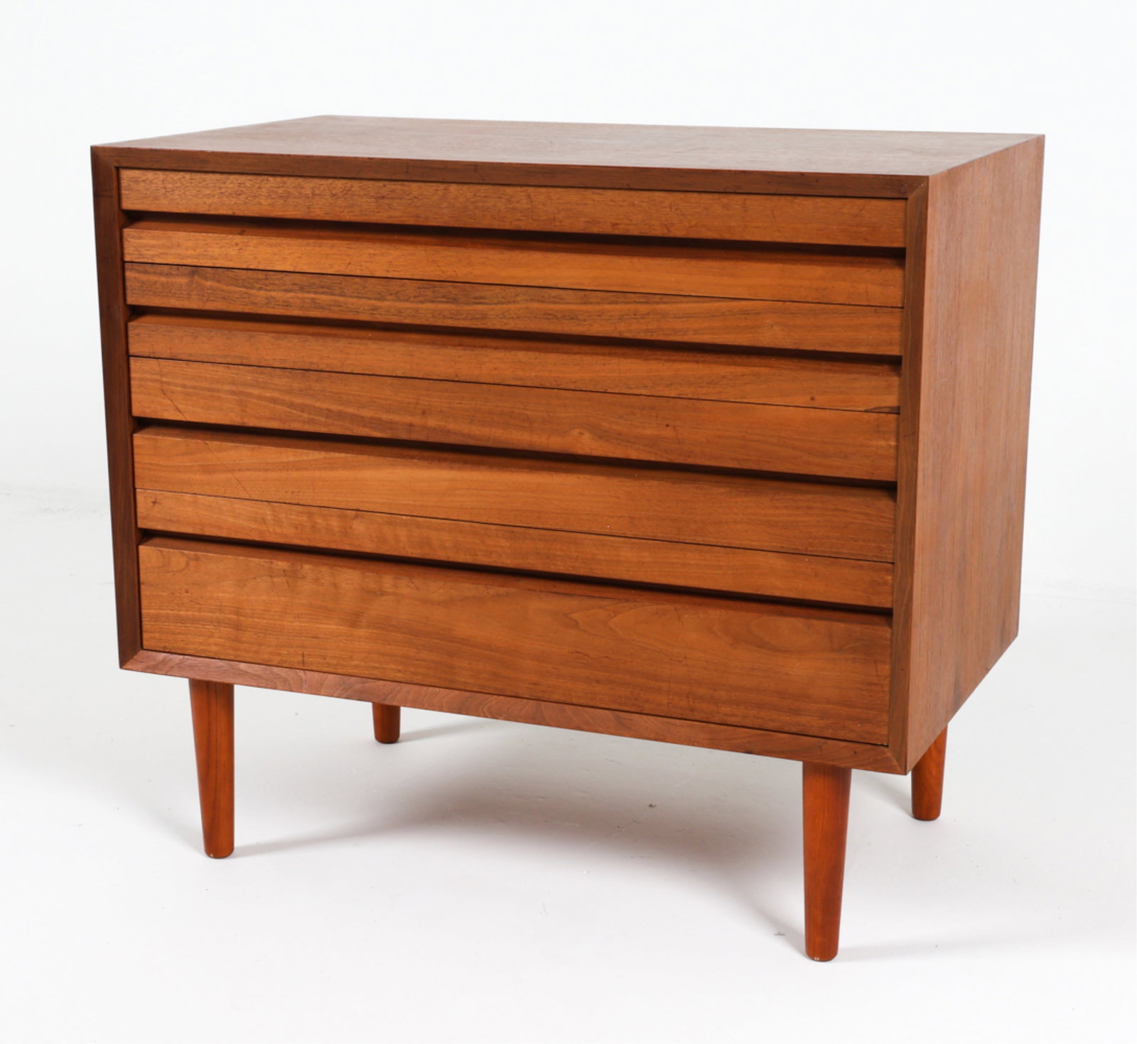 DANISH TEAK CHEST OF DRAWERS BY POUL CADOVIUS: Apparently unsigned. 4 drawers Dimensions: H 28" x W 31.5" x D 18" Condition: Wear consistent with age and use, marks and scattered scratches. Musty odor present in drawers. DMI015