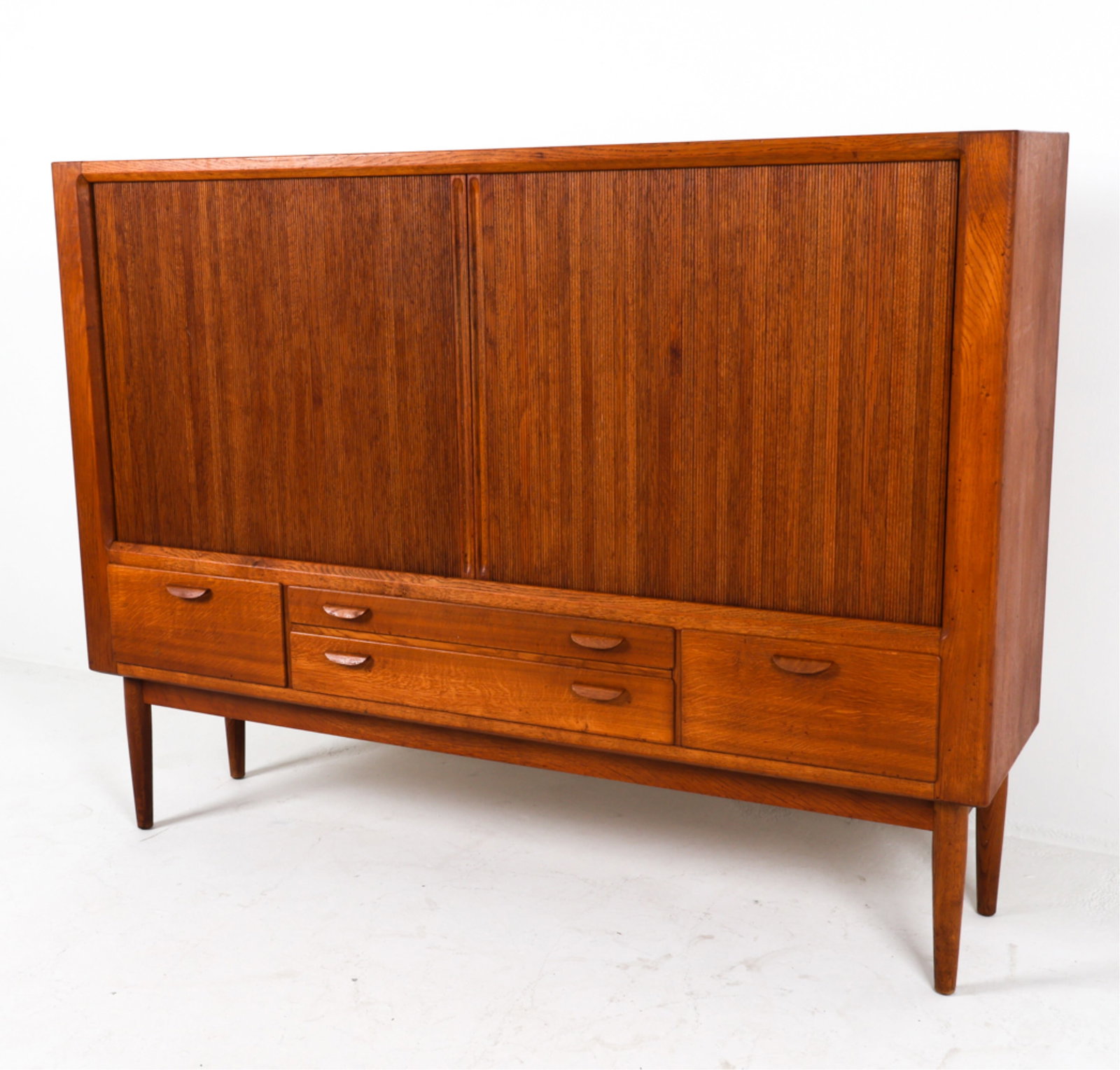 DANISH OAK SIDEBOARD W/ TAMBOUR DOORS: Interior green felted drawers and interior shelves. Adjustable shelves. Circa 1960's. Dimensions: H 51" x W 67" x D 16.5". Condition: Wear consistent with age and use. Slight odor from prior stored el