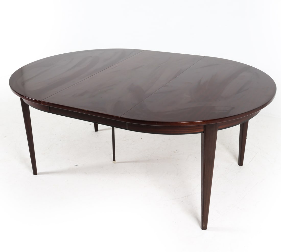 DANISH ROSEWOOD DINING TABLE BY OMANN JUN: Model No 55. (1) leaf included. Tag underneath. Extra leg folds out in middle for support with leaf installed. Dimensions: H 28" x Dia. 48". Leaf W 19.75". Condition: Wear consistent with age and use.