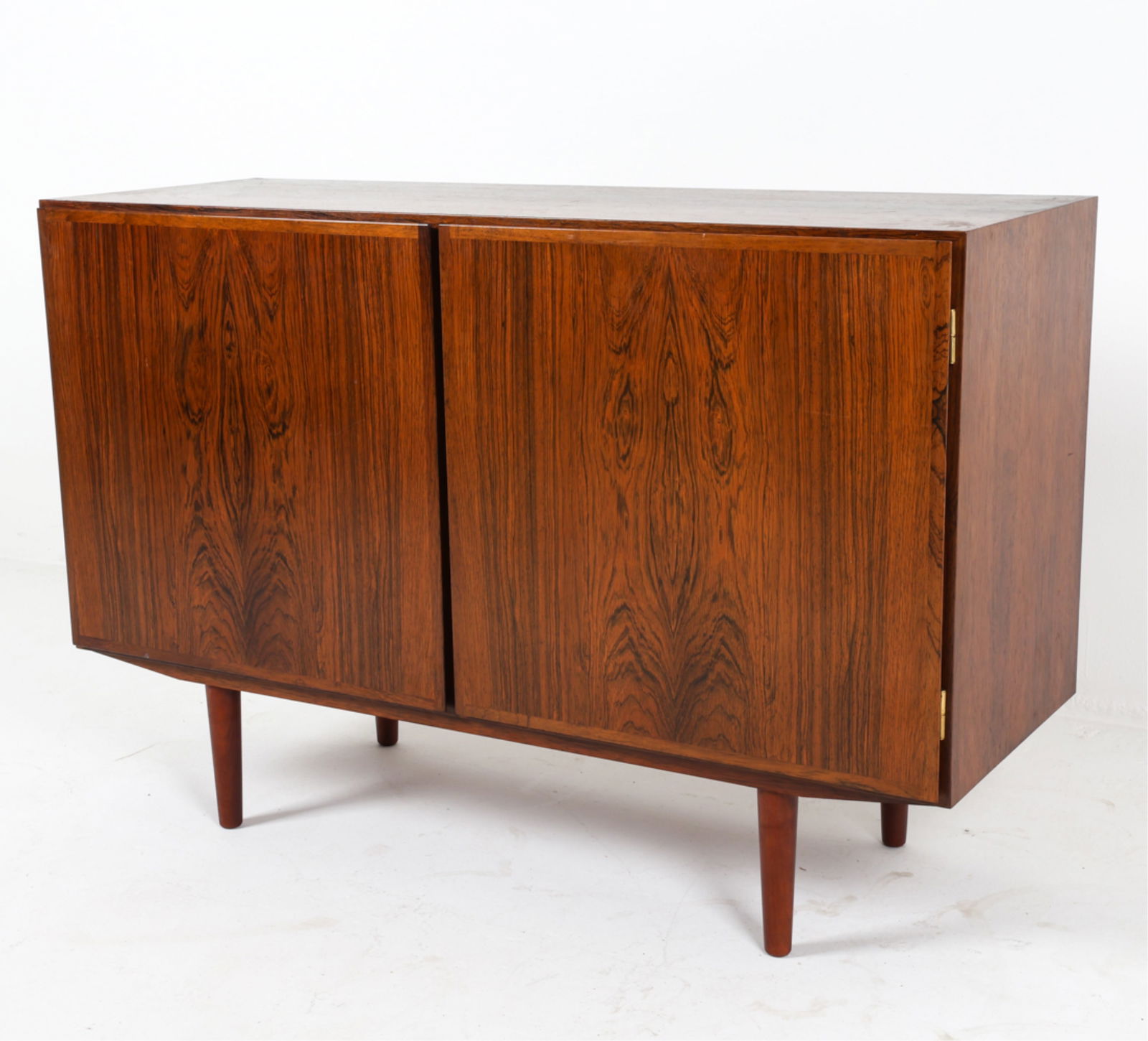 DANISH ROSEWOOD CABINET BY OMANN JUN: Model No. 4. Label inside cabinet door. Adjustable shelves. Circa 1960's. Dimensions: H 31.75" x W 47.5" x D 17.5". Condition: Legs may not be original. Wear consistent with age and use. DMI084