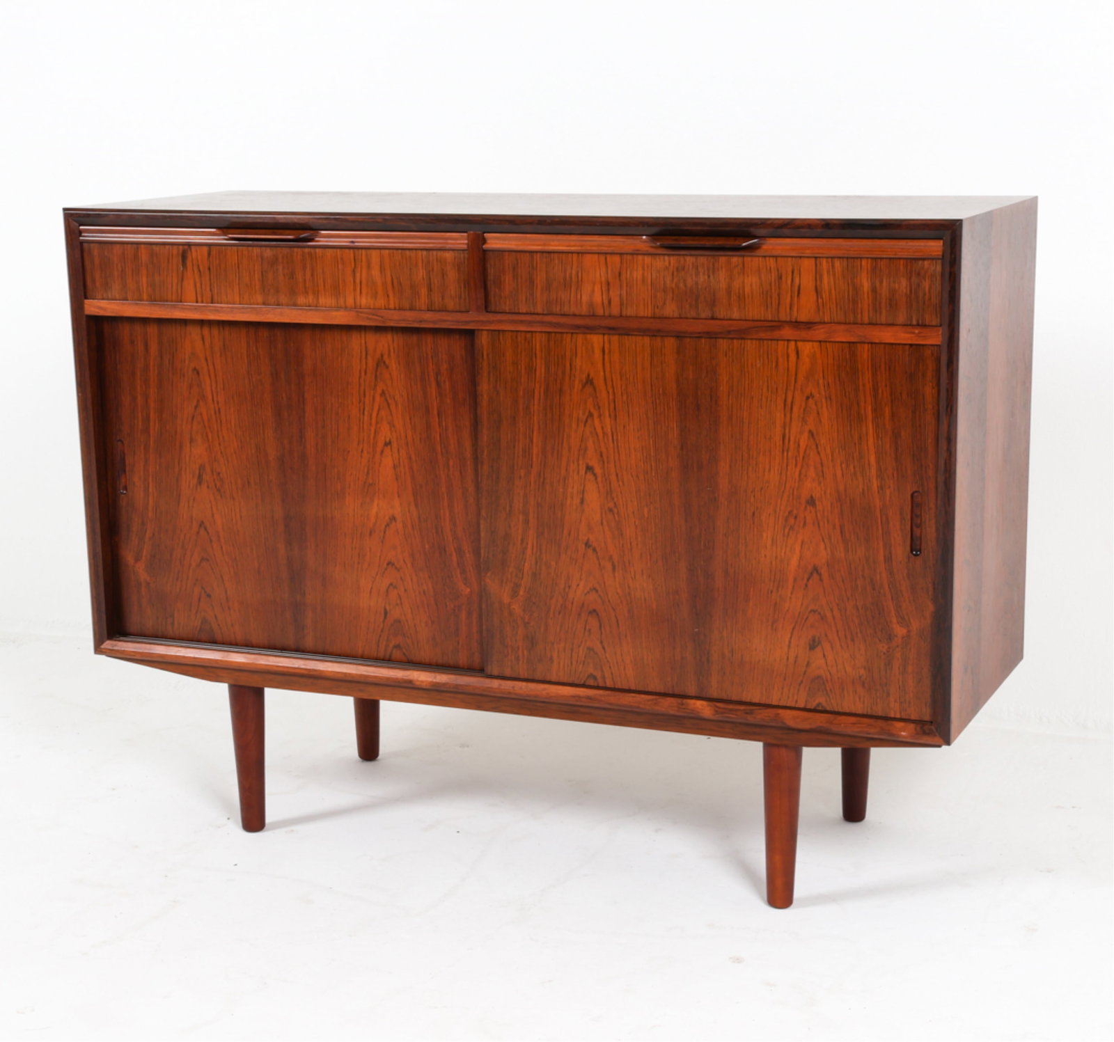 DANISH ROSEWOOD CREDENZA FROM BBM MOBLER: Carved inset divots as cabinet door pulls. Adjustable shelves. Felt lined drawers. Dimensions: H 31" x W 43.5" x D 15". Condition: Minor scuffs, faint surface scratches, wear consistent with age and u