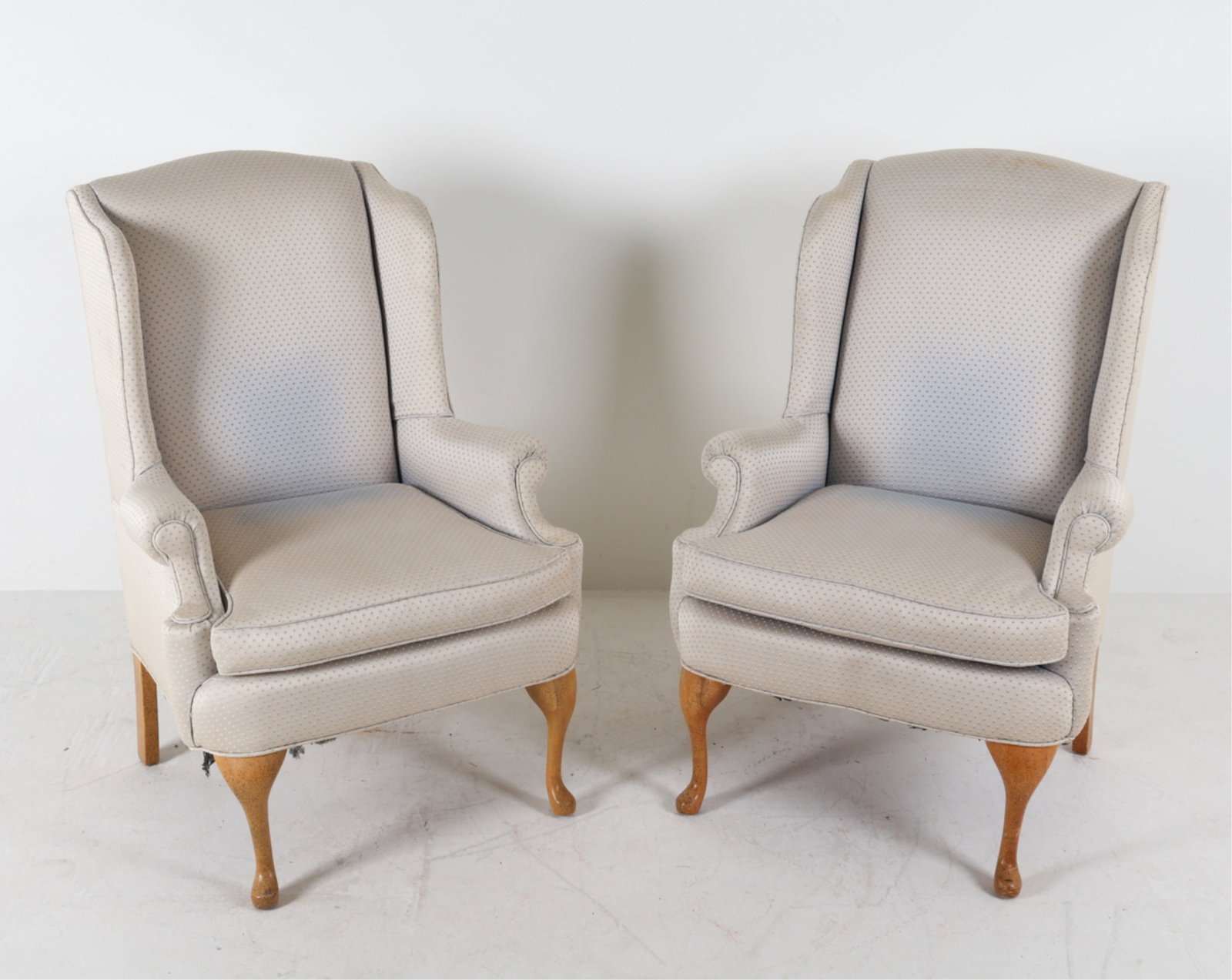 WINGBACK ARMCHAIRS: Late 20th century. Dimensions: H 42.25" x W 30" x D 25.5" x SH 19.75". Condition: Some areas of fading and discoloration to fabric. Recent reupholstery.