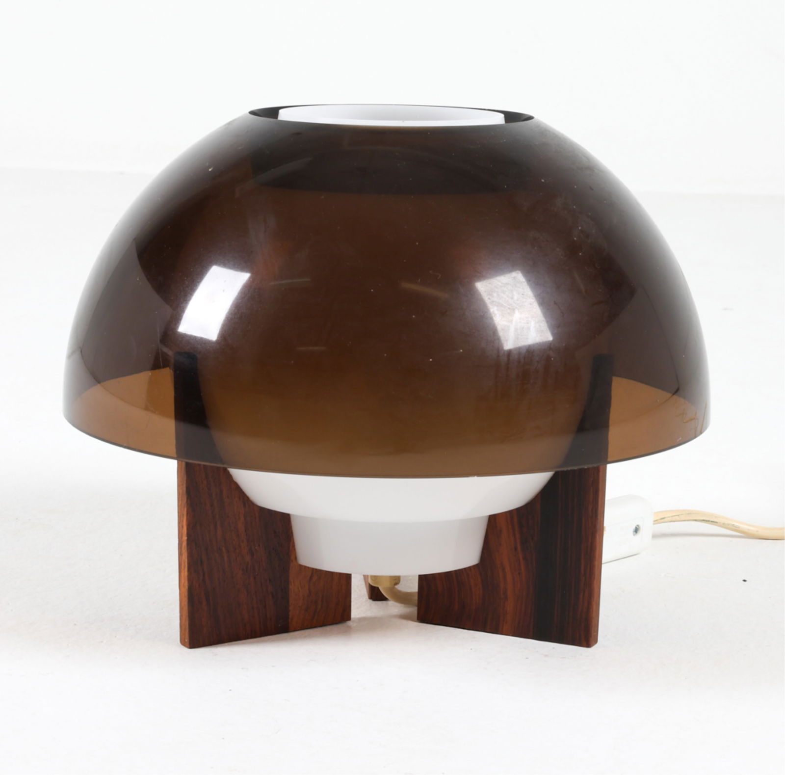 'SPIKA-O' DESK LAMP BY BENT KARLBY: For ASK Lighting. Rosewood base with plexiglass shade. Original tag and label. Circa 1970's. Dimensions: H 8.25" x Dia. 10.25". Condition: Wiring untested, European plug - requires adapter or rewiring