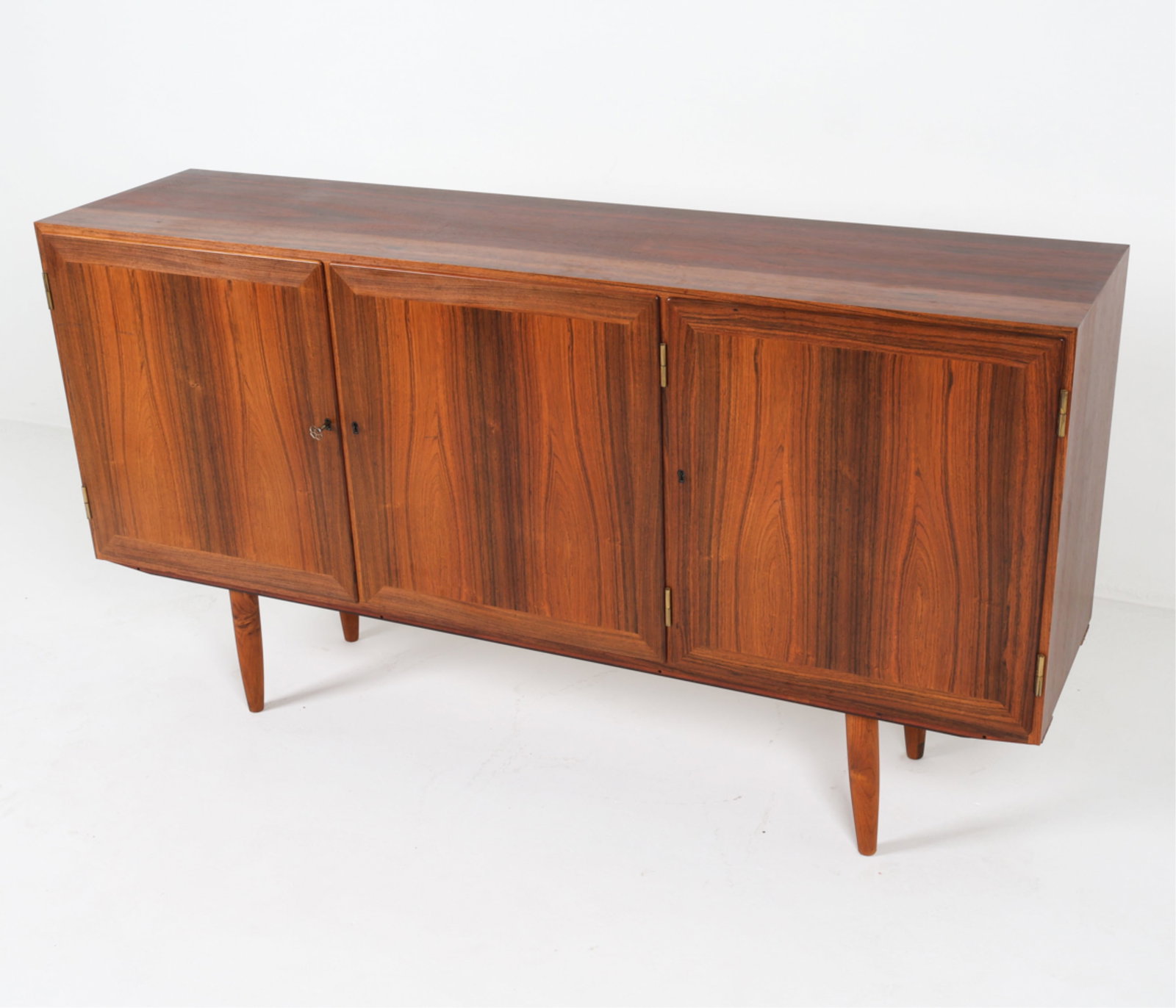 DANISH ROSEWOOD SIDEBOARD, CIRCA 1960'S: Key included. Adjustable shelves. Dimensions: H 35" x W 65.25" x D 15.75". Condition: Faint scuffs on front, wear consistent with age and use. Scattered thin scratches inside. PER A110
