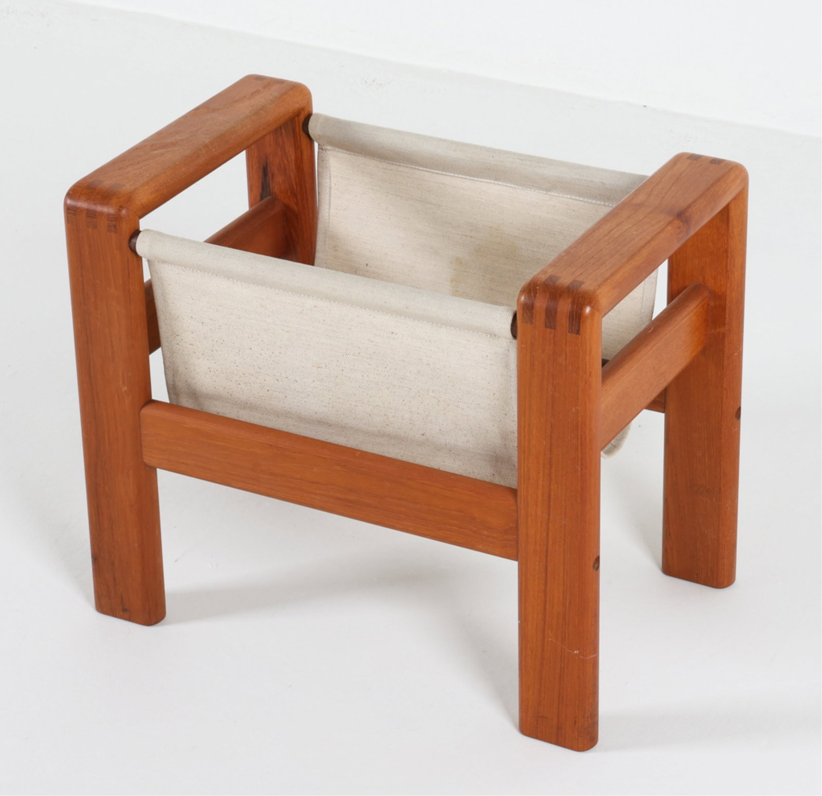 DANISH TEAK AND CANVAS MAGAZINE RACK, C.1970'S: Dimensions: H 16.5" x W 19.5" x D 12.25". Conditions: Light surface wear consistent with age and use, a few areas of sun fading, PER A18